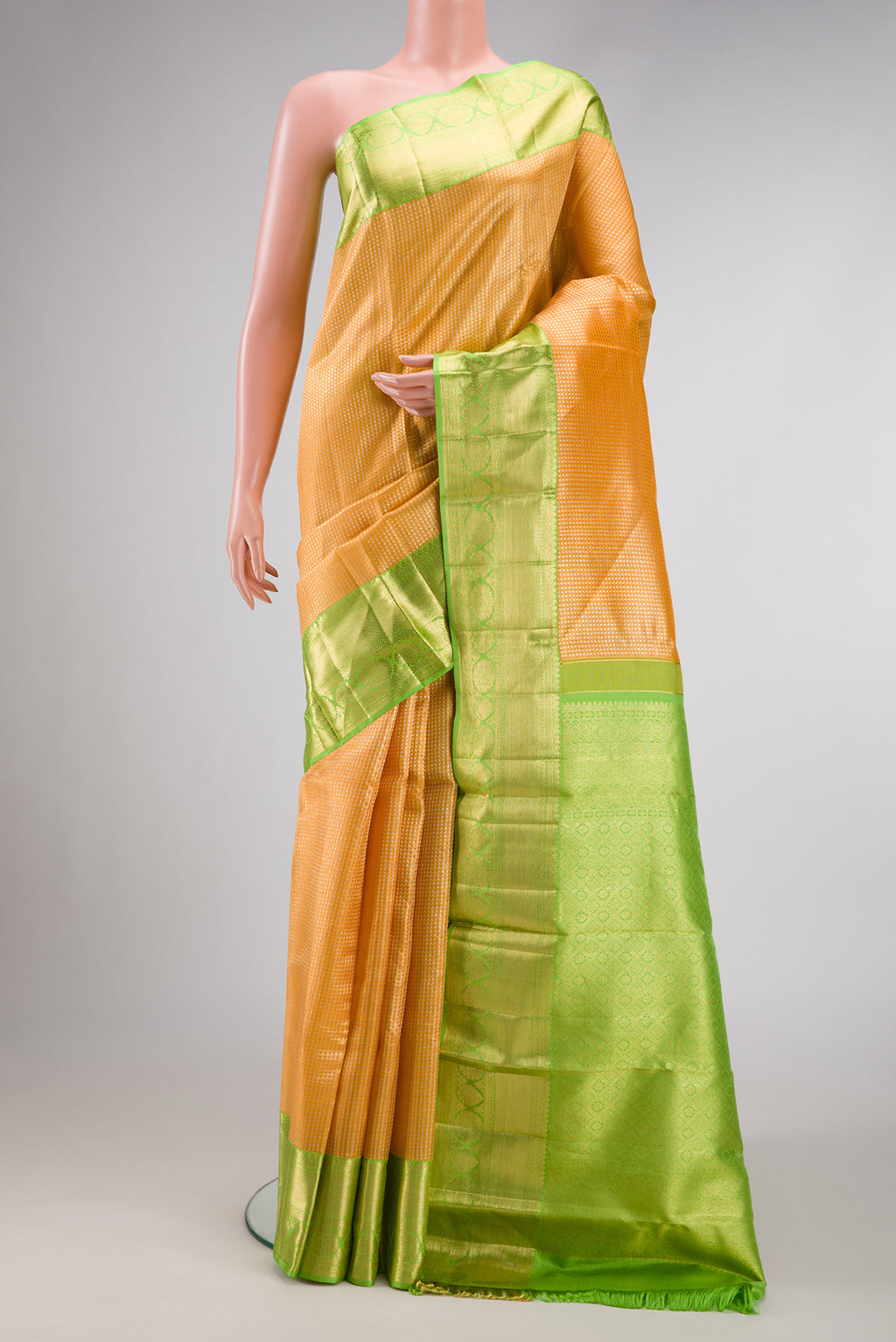 Golden Peach Dual Tone Kanchipuram Tissue Silk Saree with Zari Brocade on the body and Zari Border.  displayed on a mannequin
