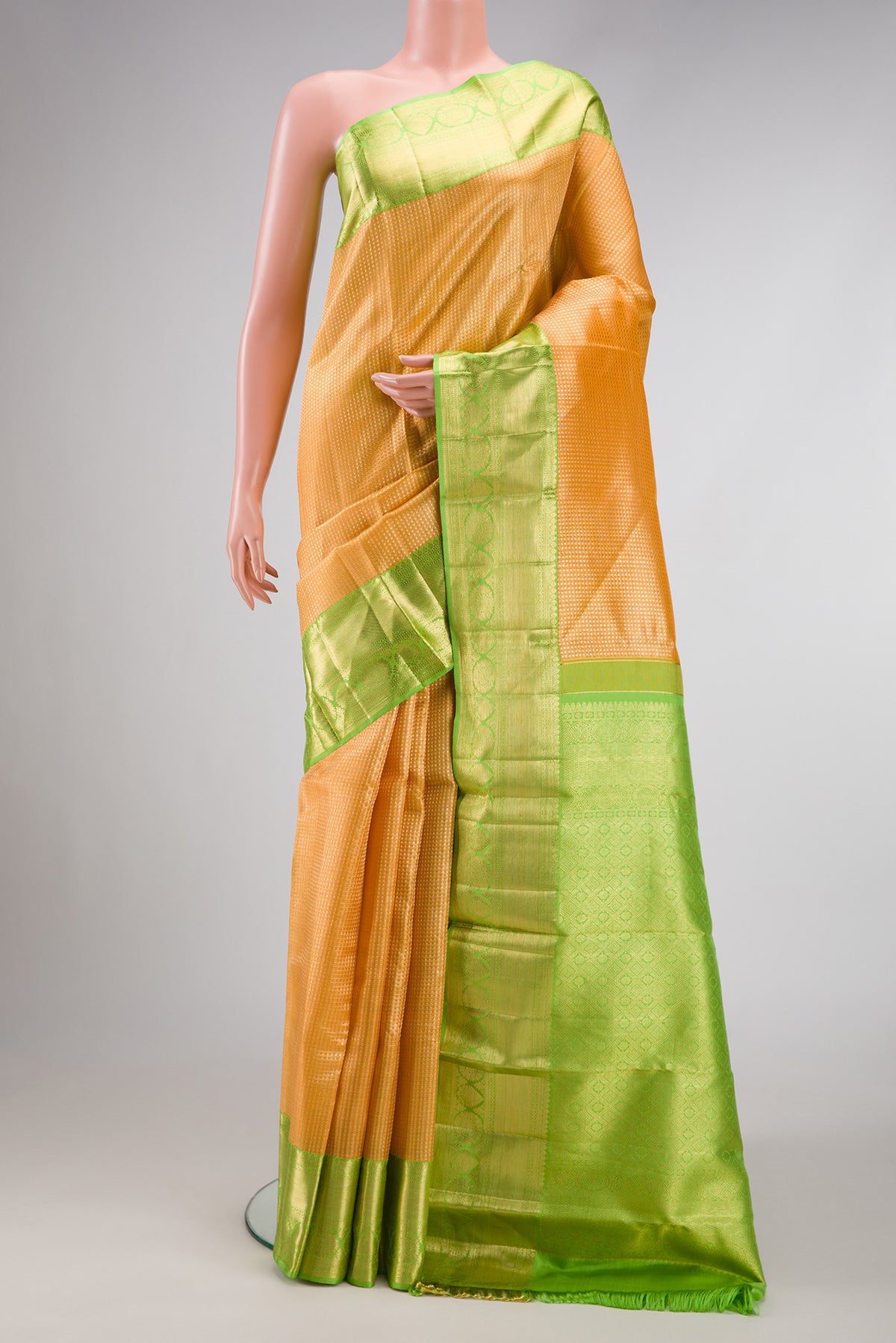 Golden Peach Dual Tone Kanchipuram Tissue Silk Saree with Zari Brocade on the body and Zari Border.  displayed on a mannequin