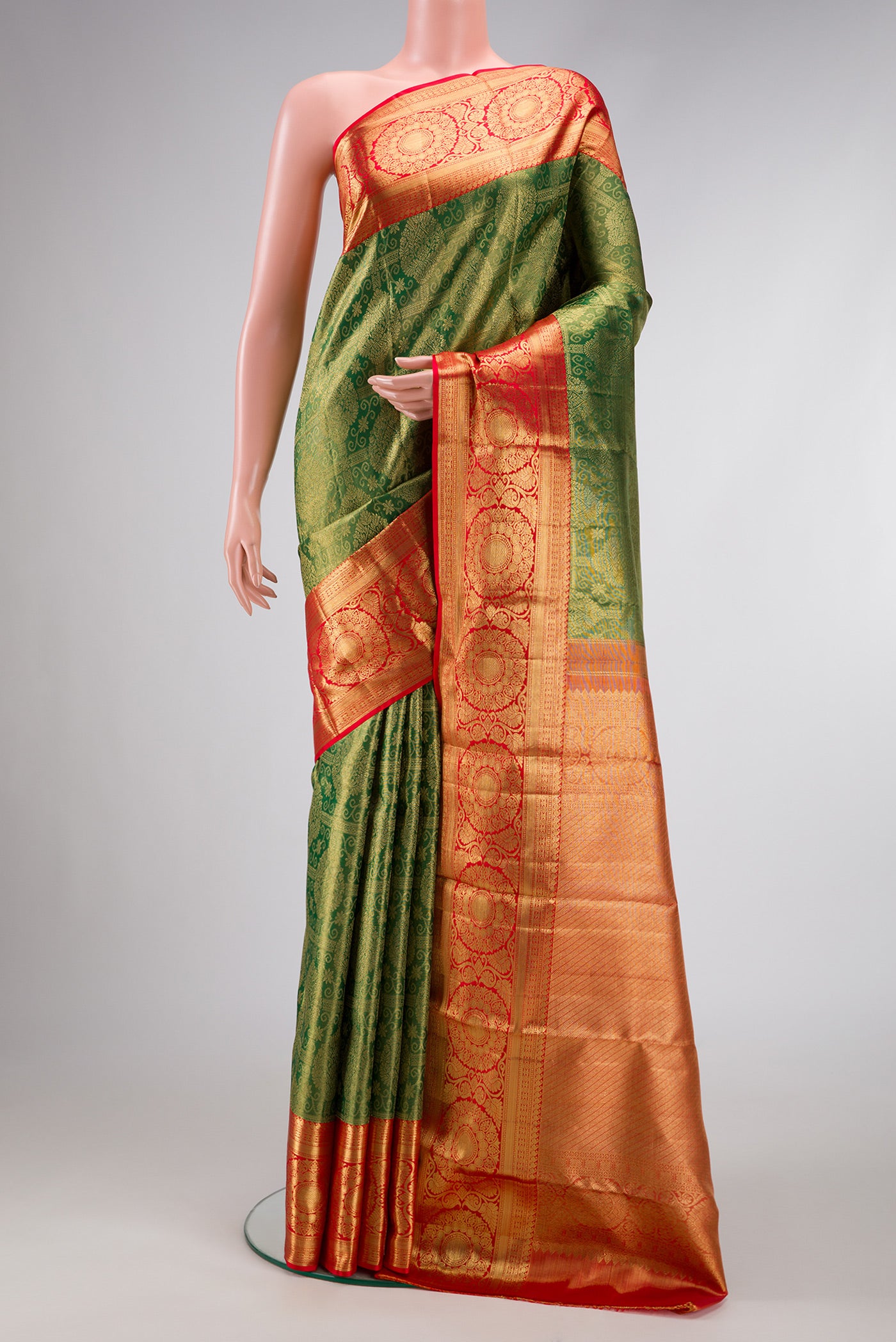 Green Dual Tone Kanchipuram Silk Saree with Zari Brocade on the body and Zari Border.  displayed on a mannequin