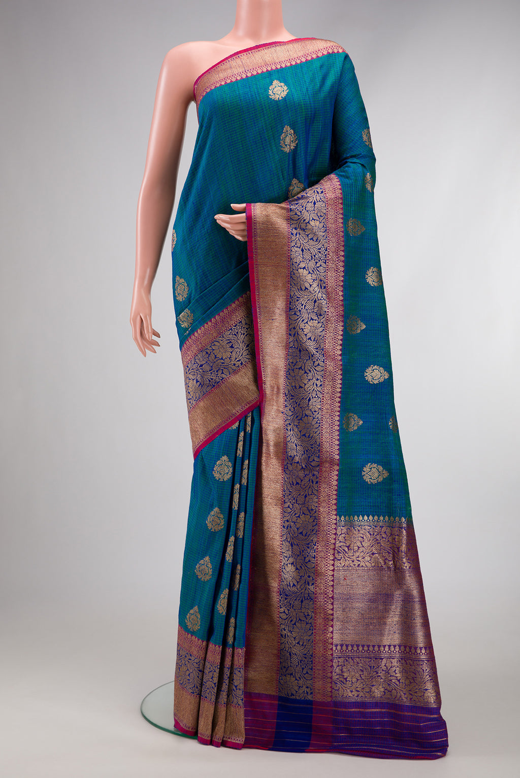 Peacock Blue Dual Tone Banarasi Silk Saree with Zari Butta on the body and Fancy Border.  displayed on a mannequin