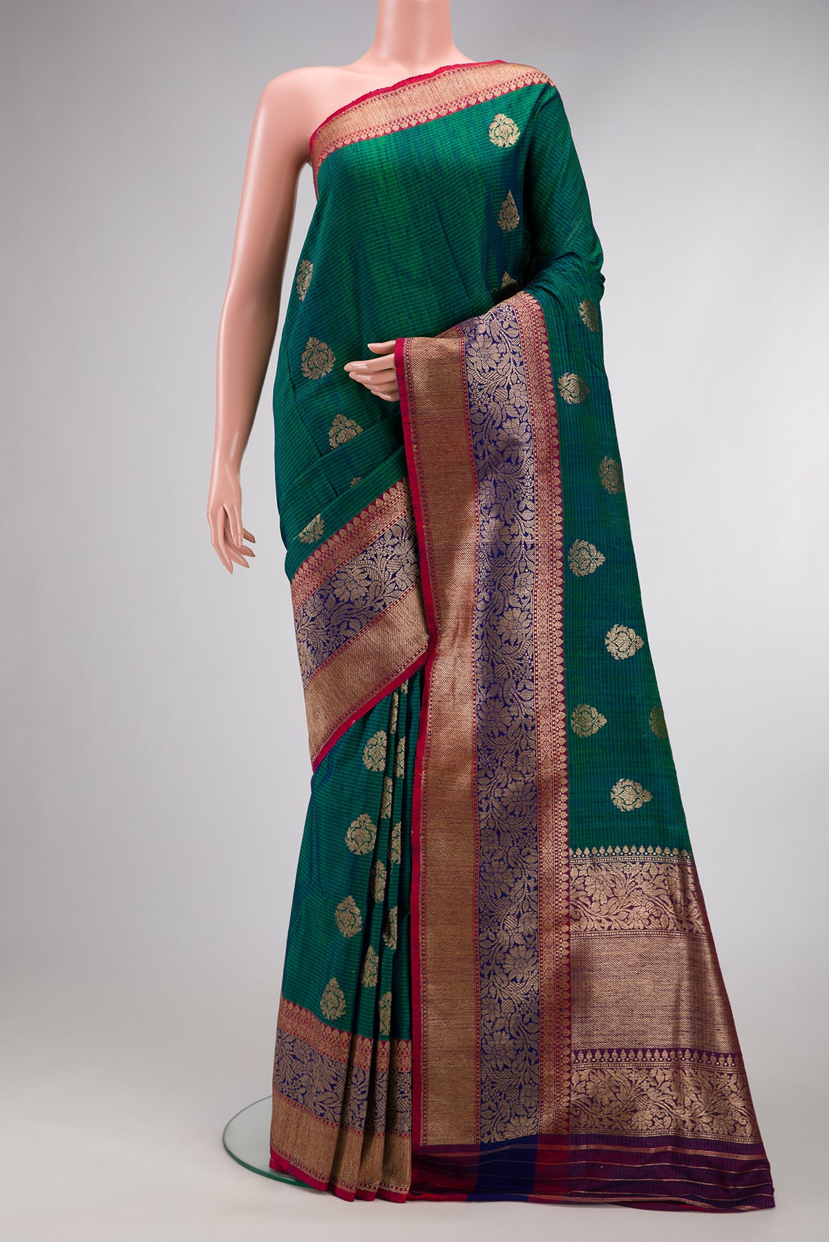 Green Dual Tone Banarasi Silk Saree with Zari Butta on the body and Fancy Border.  displayed on a mannequin