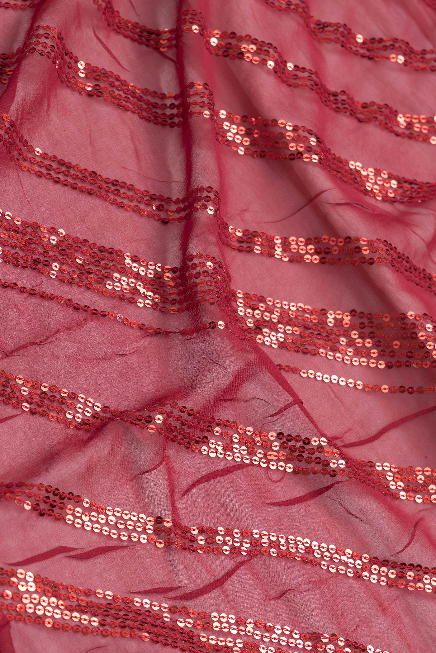 Close up of Maroon Dual Tone Mysore Georgette Saree with Embroidery on the body and Embroidery Border.  displaying folds