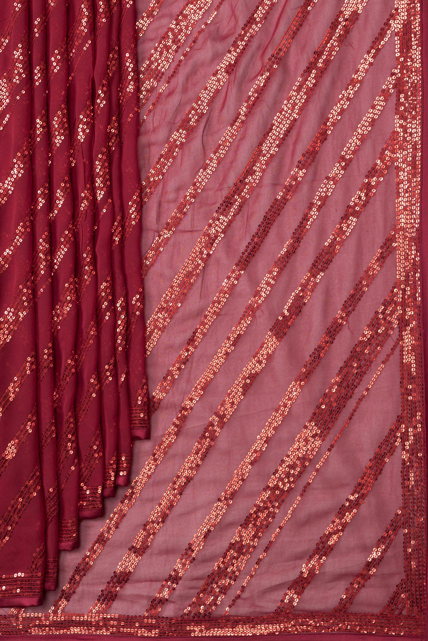 Pleats and pallu of Maroon Dual Tone Mysore Georgette Saree with Embroidery on the body and Embroidery Border. 