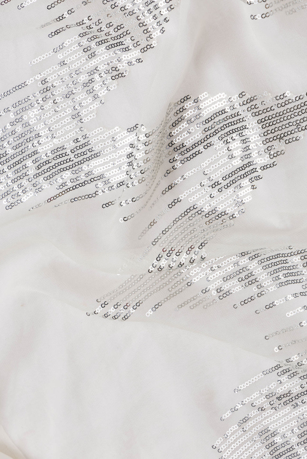 Close up of Off White Dual Tone Georgette Saree with Embroidery on the body and Without Border.  displaying folds