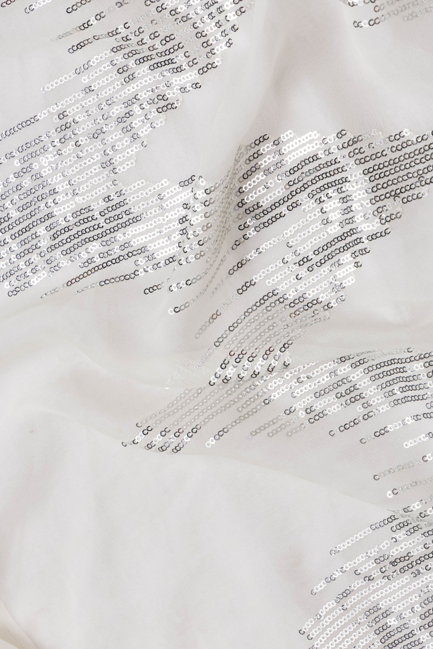 Close up of Off White Dual Tone Georgette Saree with Embroidery on the body and Without Border.  displaying folds