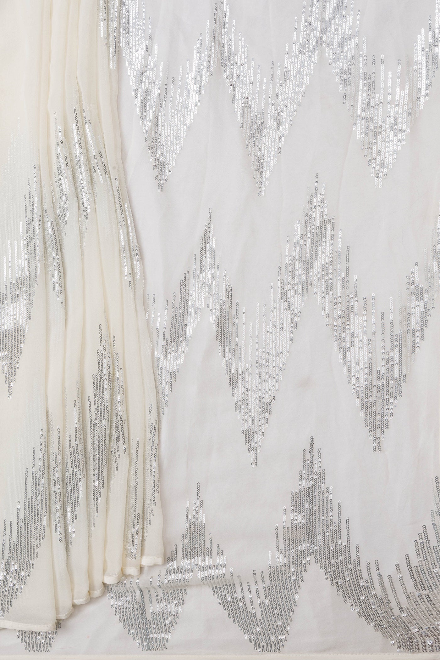 Pleats and pallu of Off White Dual Tone Georgette Saree with Embroidery on the body and Without Border. 