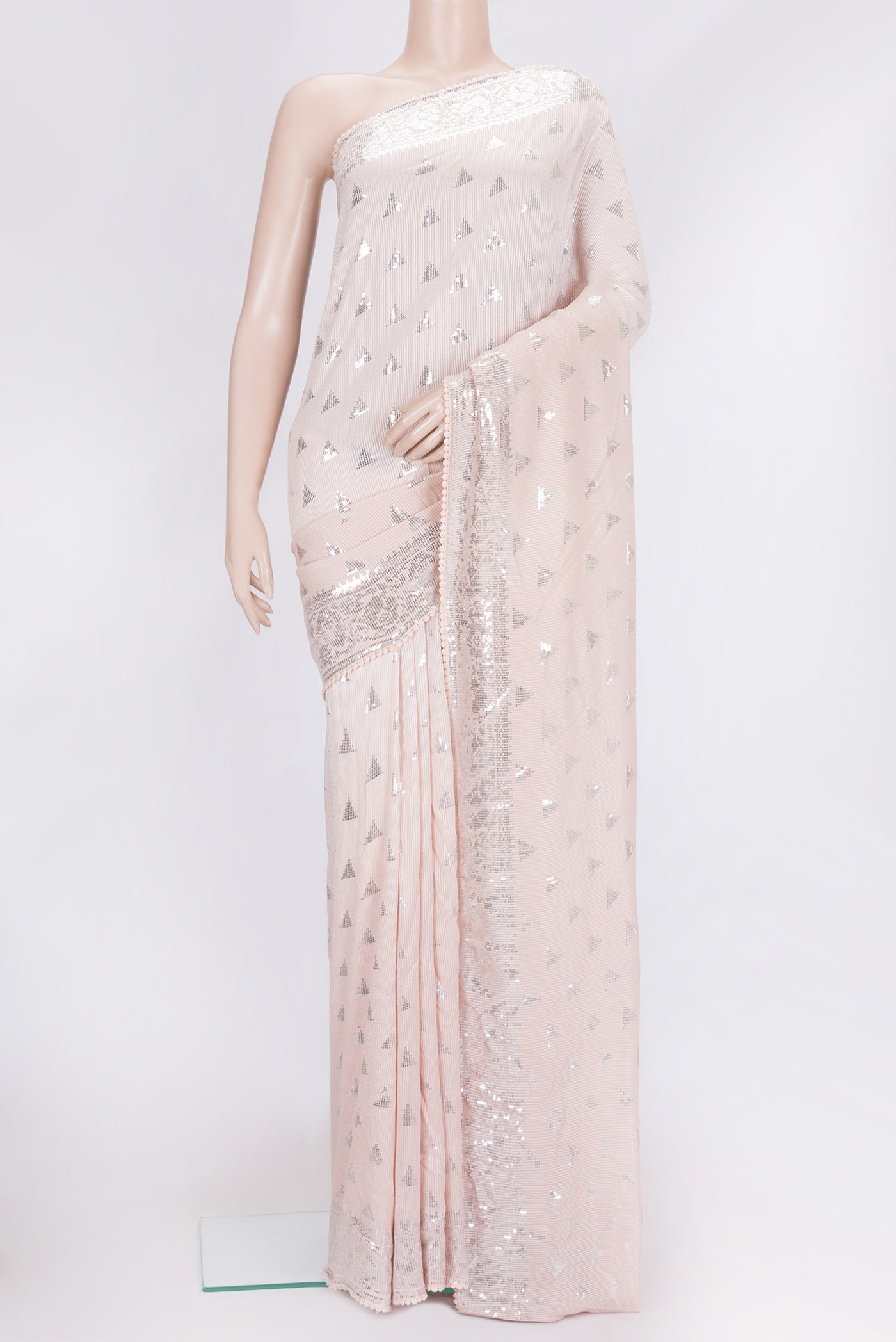 Peach Dual Tone Georgette Saree with Embroidery on the body and Embroidery Border.  displayed on a mannequin