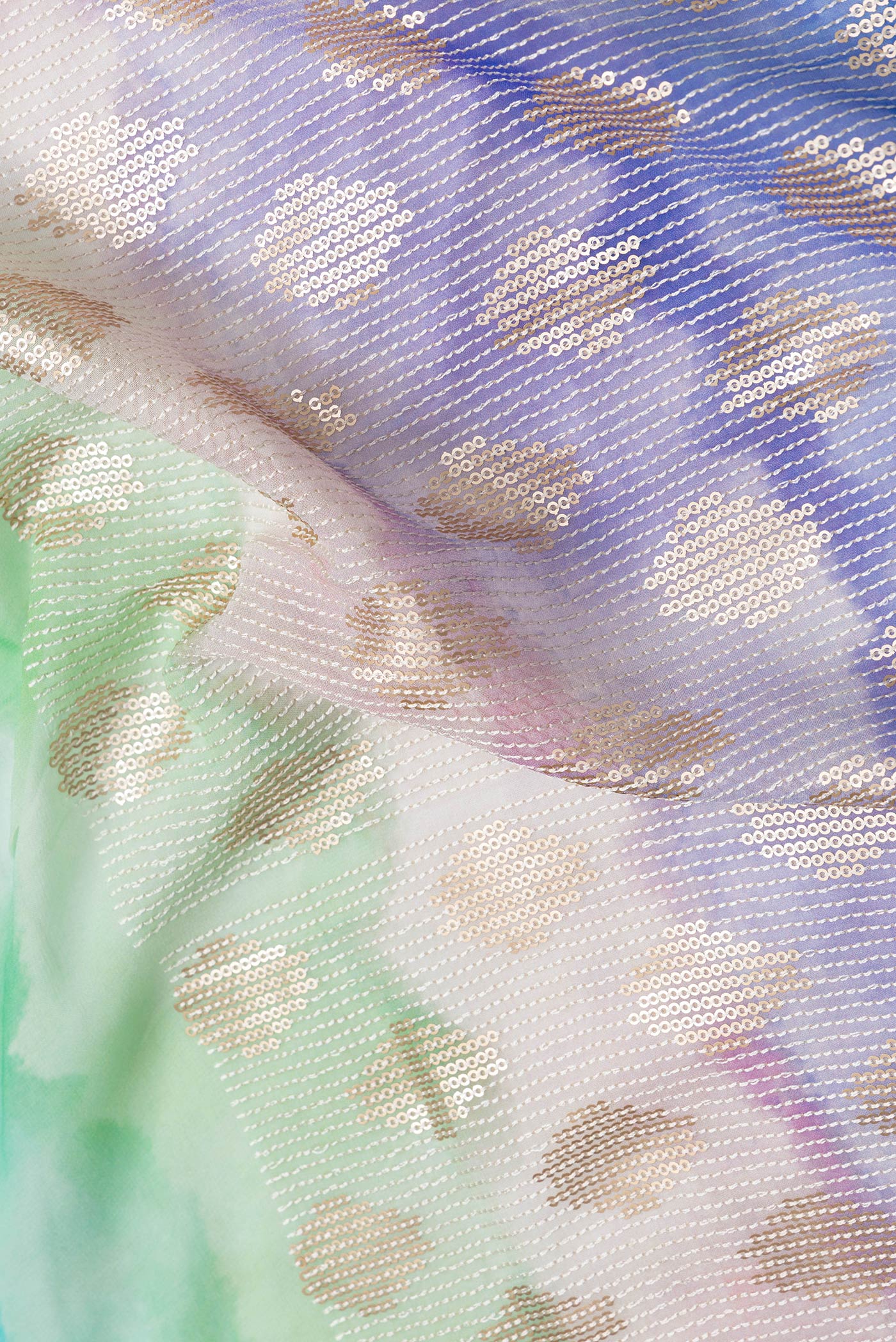 Close up of Off White Dual Tone Georgette Saree with Embroidery on the body and Embroidery Border.  displaying folds