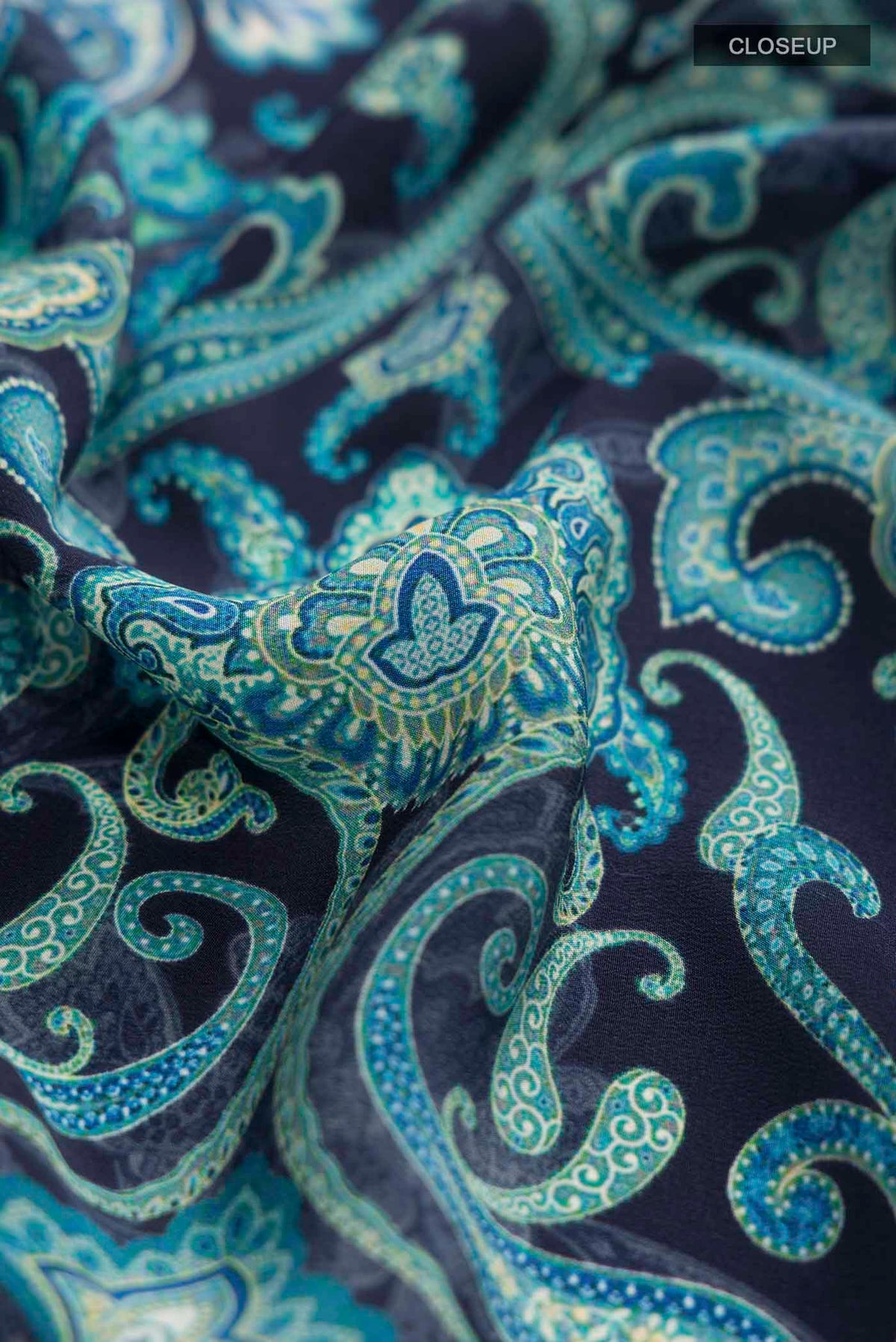 Close up of Navy Blue Mysore Crepe Saree with Printed design on the body and Plain Border displaying folds