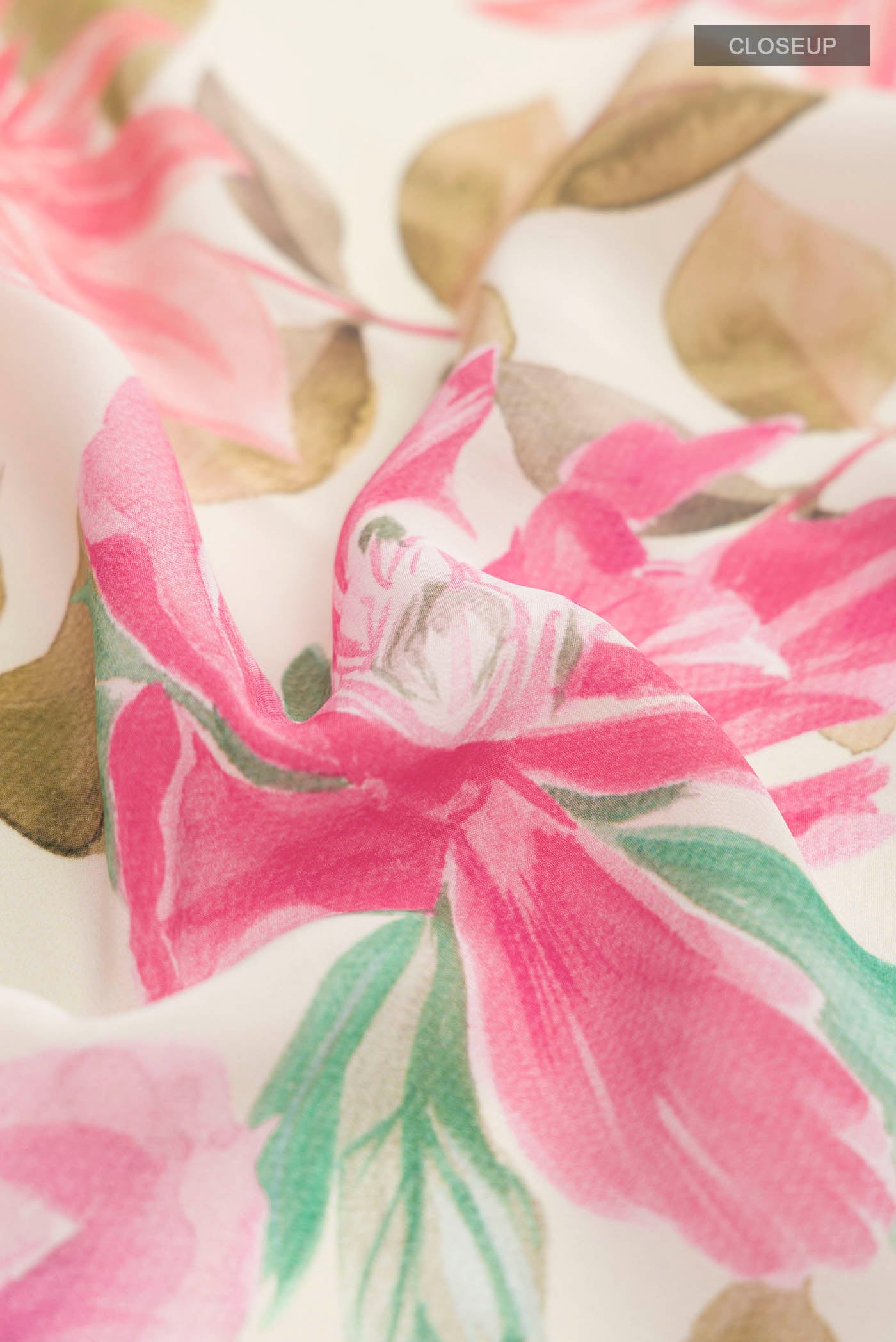 Close up of Cream Mysore Crepe Saree with Floral Print on the body and Without Border displaying folds