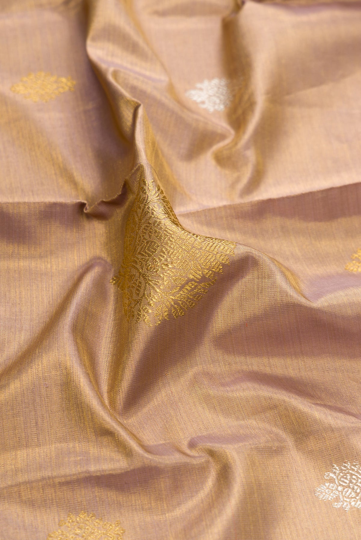 Close up of Gold Dual Tone Kanjivaram Tissue Silk Saree with Zari Brocade on the body and Zari Border.  displaying folds