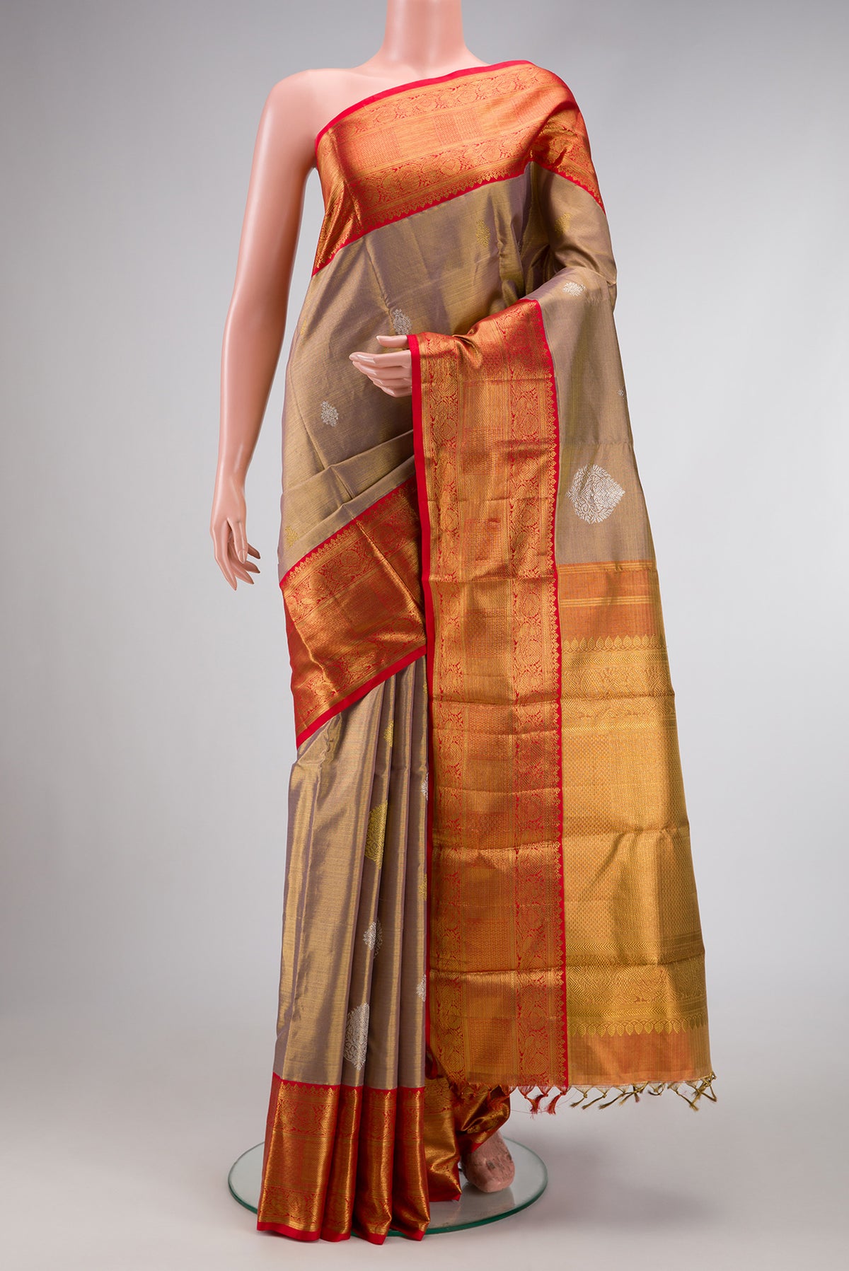 Gold Dual Tone Kanjivaram Tissue Silk Saree with Zari Brocade on the body and Zari Border.  displayed on a mannequin