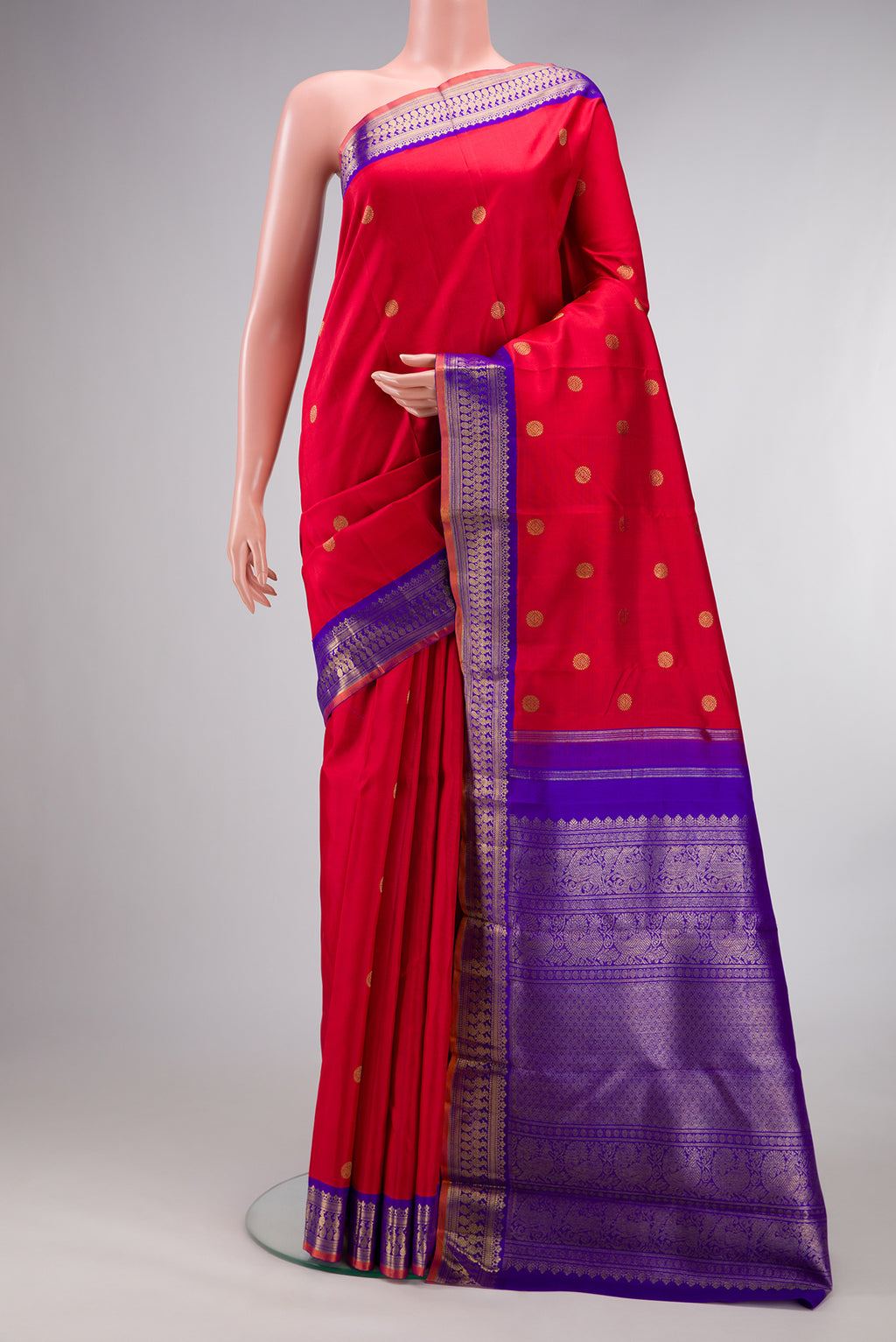 Pure Silk Pure Zari Red Kanjivaram Saree with Zari Butta on the body and Fancy Border.  displayed on a mannequin