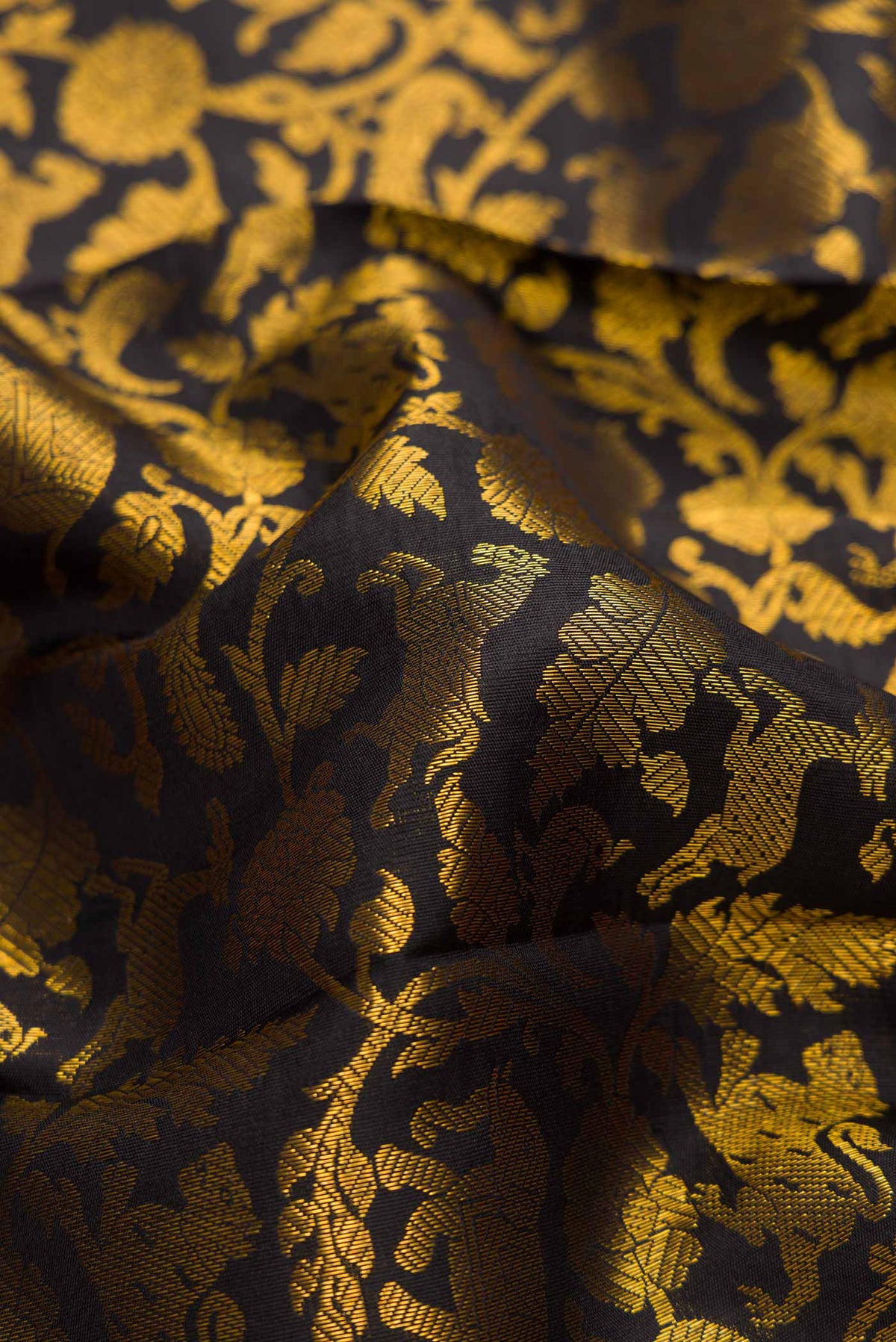 Close up of Black Dual Tone Kanjivaram Silk Saree with Zari Brocade on the body and Zari Border.  displaying folds