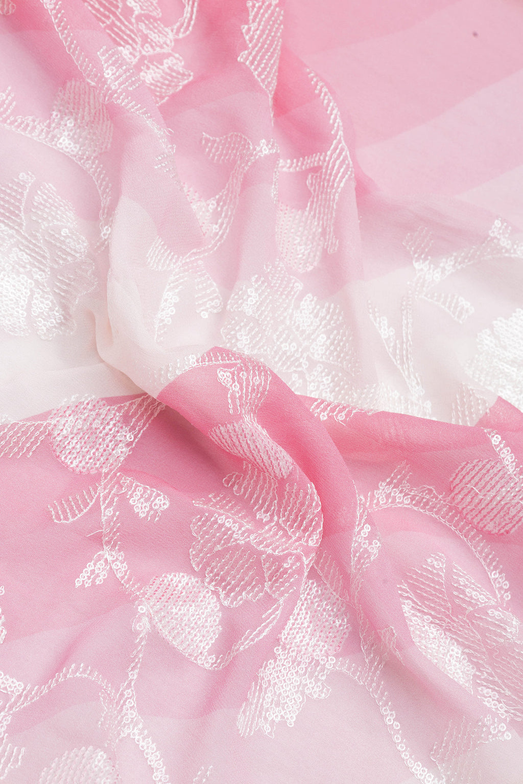 Close up of Pink Dual Tone Georgette Saree with Embroidery on the body and Embroidery Border.  displaying folds