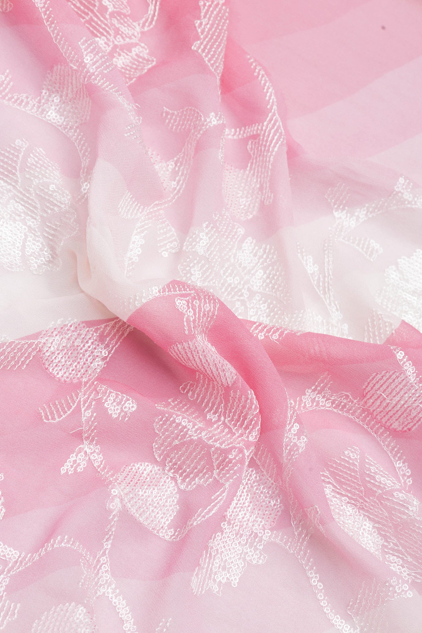 Close up of Pink Dual Tone Georgette Saree with Embroidery on the body and Embroidery Border.  displaying folds