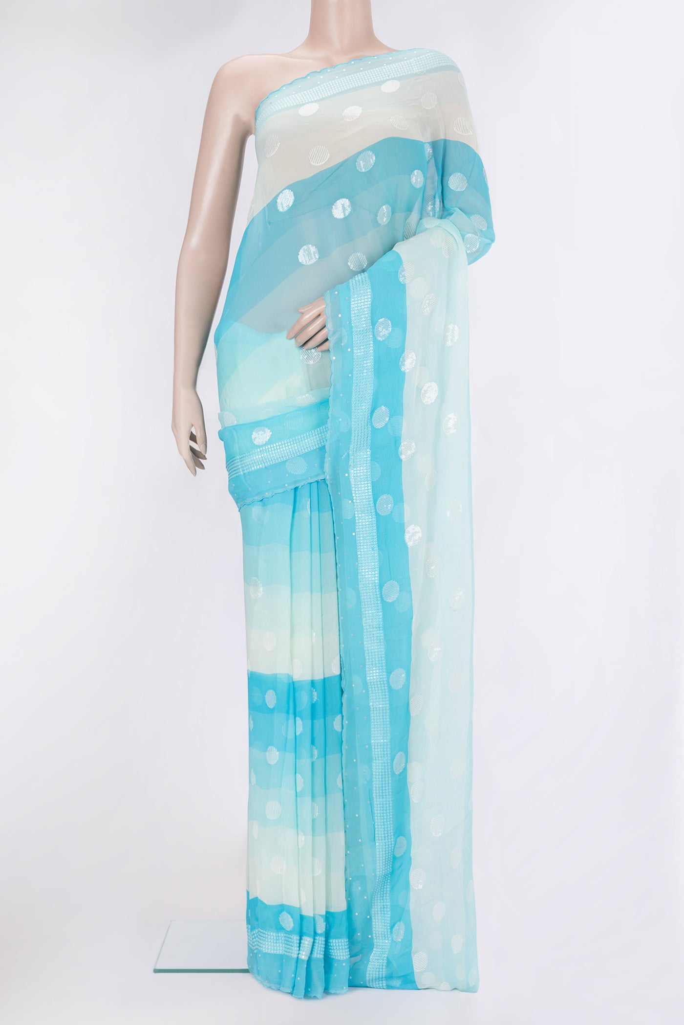 Sky Blue and Beige Color Georgette Saree with Embroidery on the body and Embroidery Border.  displayed on a mannequin