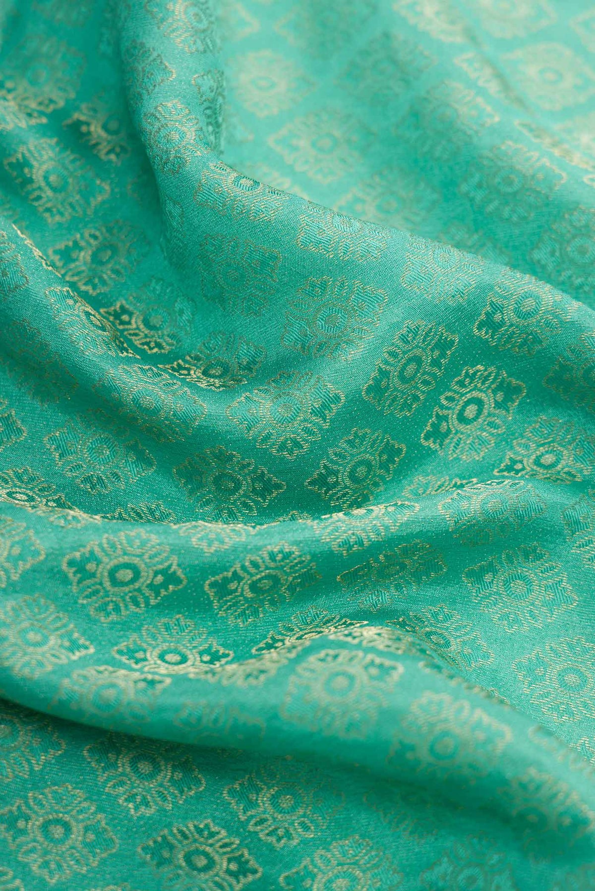 Close up of Sea Green Dual Tone Banarasi Georgette Saree with Zari Brocade on the body and Zari Border.  displaying folds