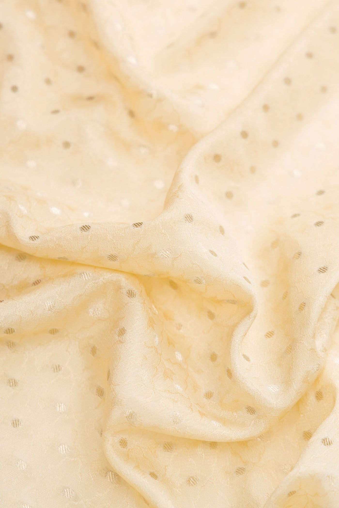 Close up of Beige Dual Tone Banarasi Georgette Saree with Jacquard With Zari Butta on the body and Zari Border.  displaying folds