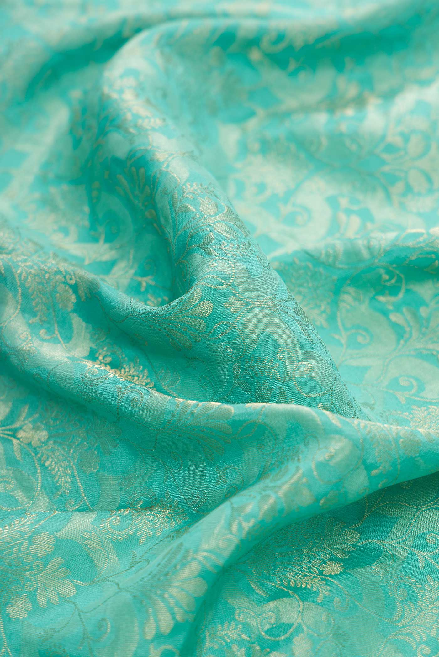 Close up of Sky Blue Dual Tone Banarasi Georgette Saree with Zari Brocade on the body and Zari Border.  displaying folds