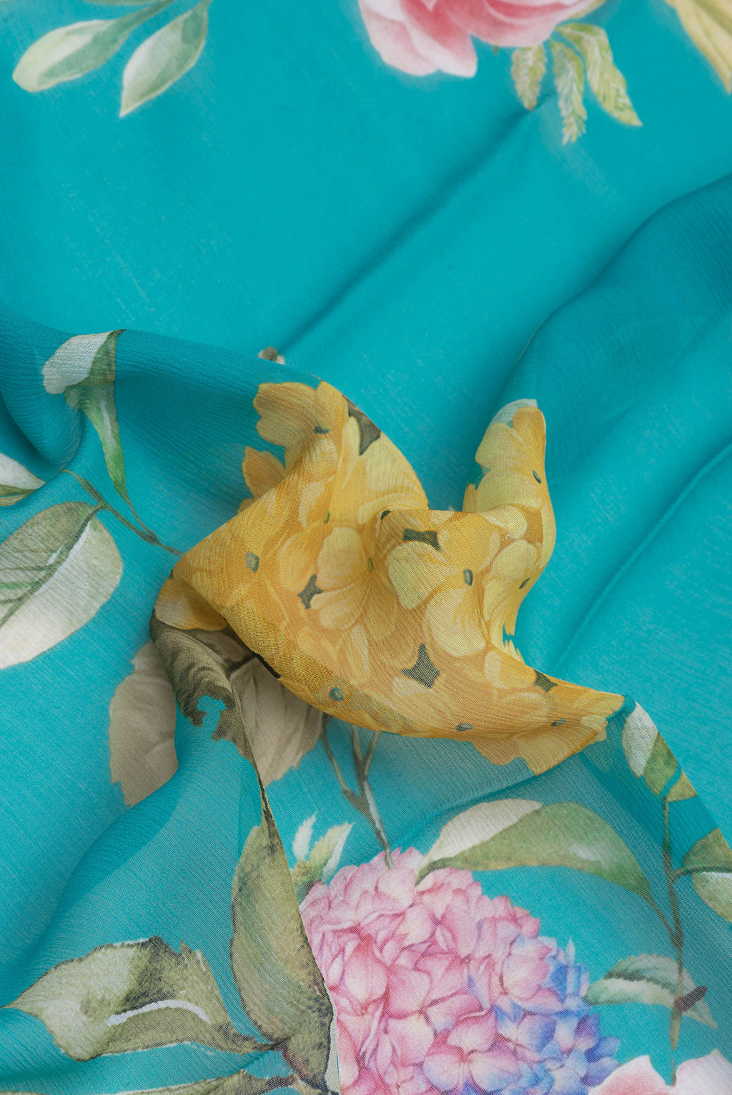 Close up of Sky Blue Mysore Chiffon Saree with Printed design on the body and Without Border.  displaying folds