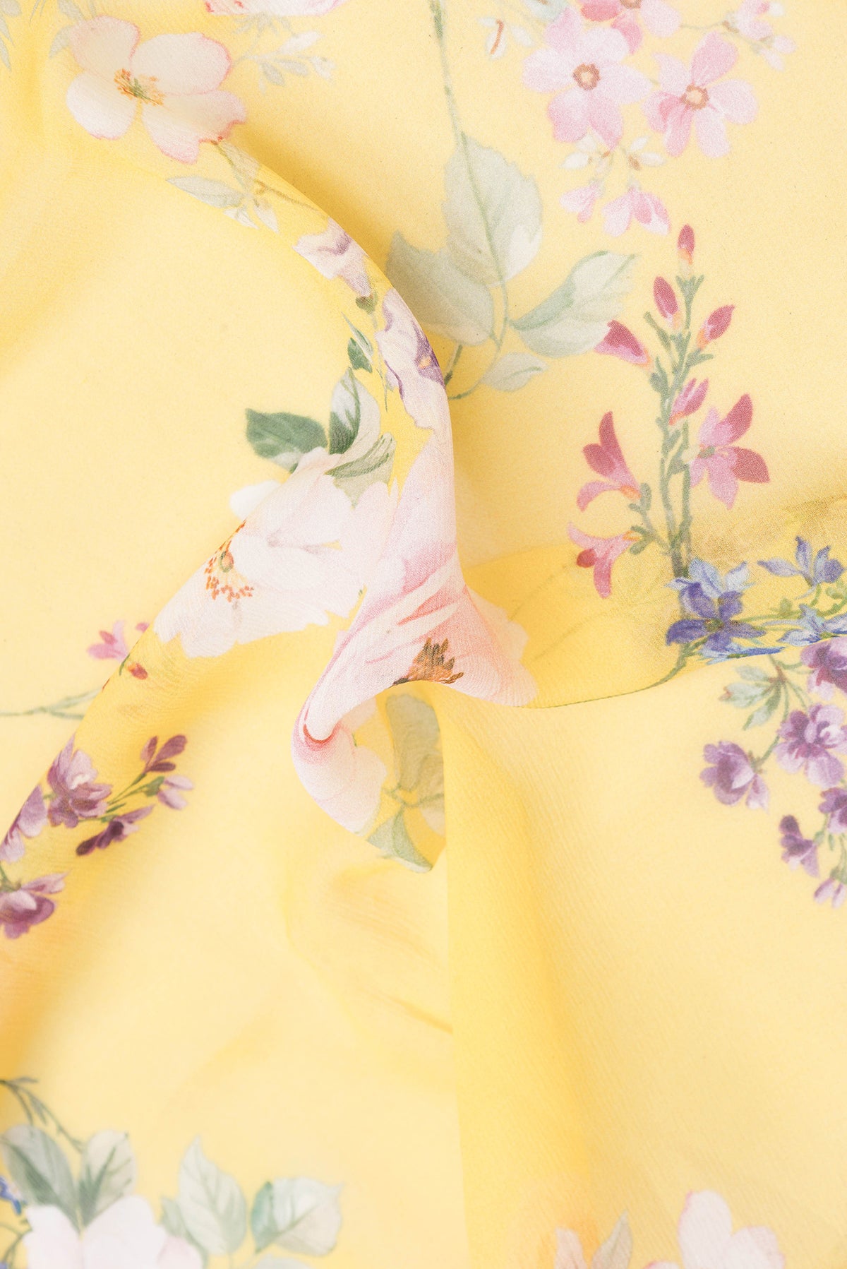 Close up of Yellow Mysore Chiffon Saree with Printed design on the body and Without Border.  displaying folds