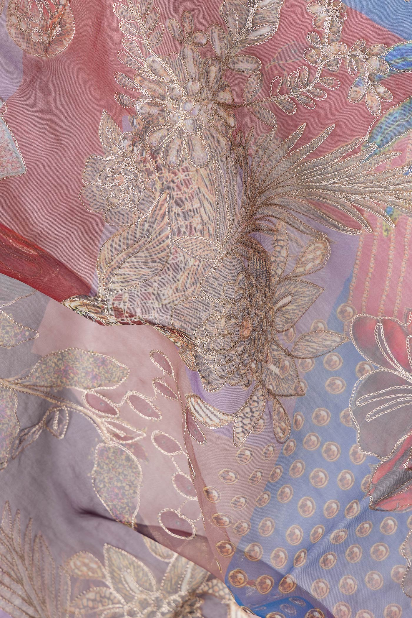 Close up of Purple Dual Tone Organza Silk Saree with Printed design on the body and Embroidery Border.  displaying folds