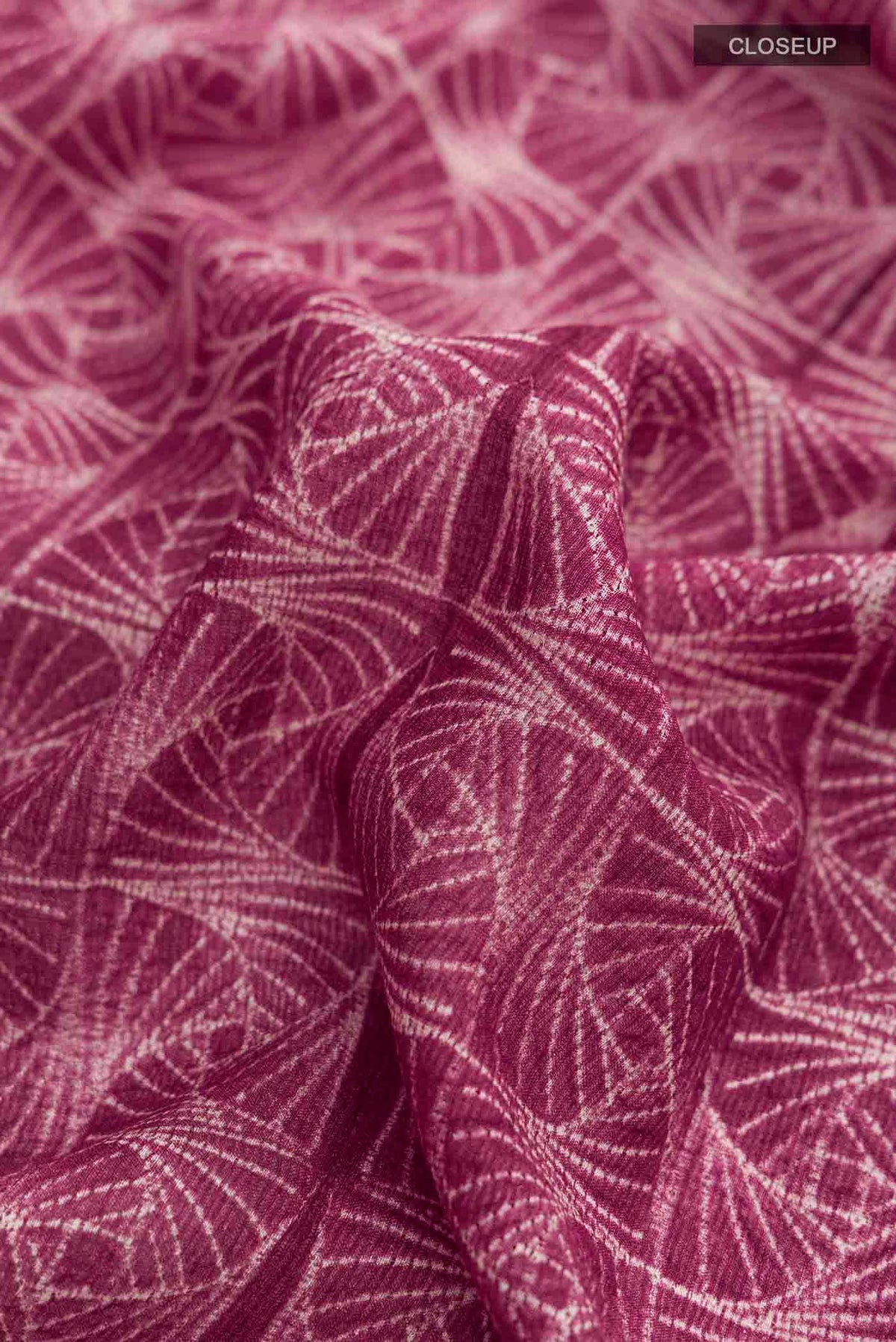 Close up of Mauve Tussar Silk Saree with Printed design on the body and Zari Border displaying folds