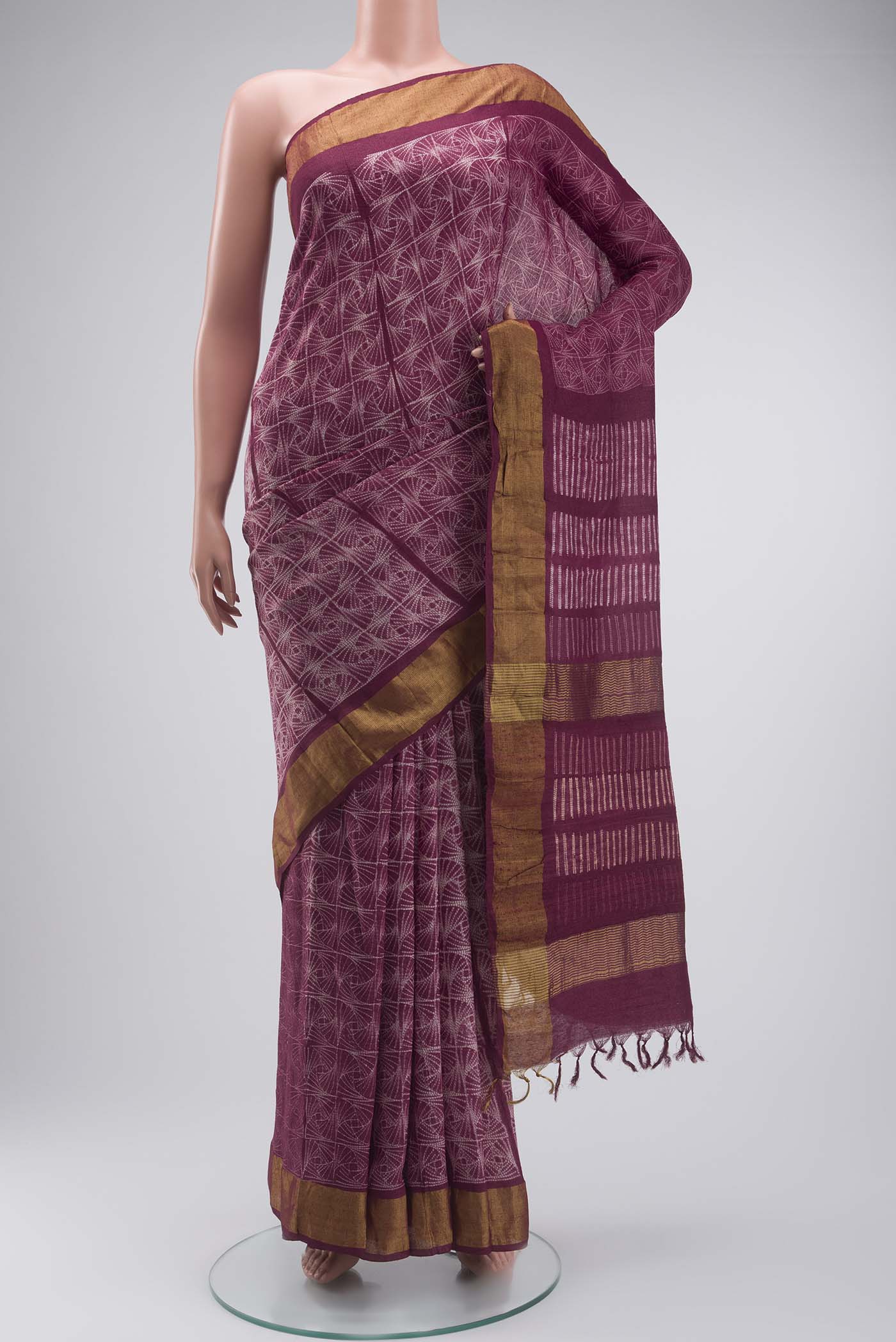 Mauve Tussar Silk Saree with Printed design on the body and Zari Border displayed on a mannequin