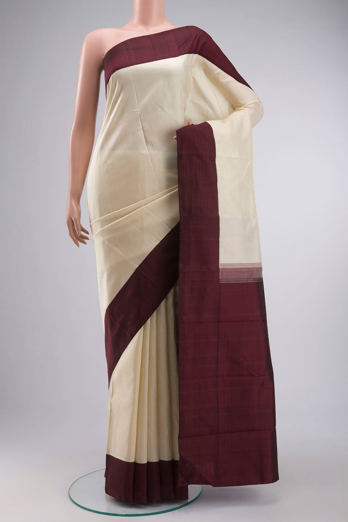 Cream Kanchipuram Silk Saree with Plain Body and Plain Border displayed on a mannequin