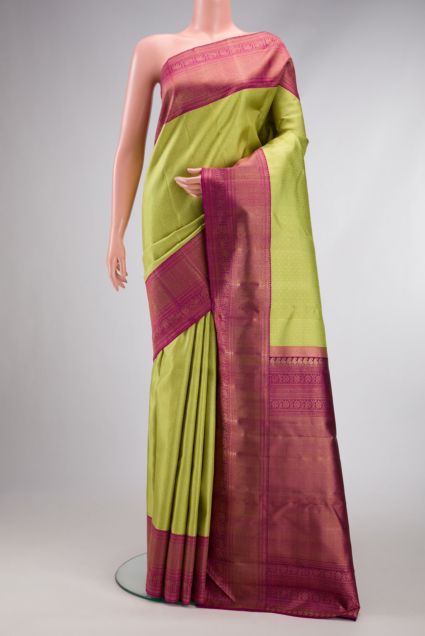 Pure Silk Pure Zari Parrot Green Dual Tone Kanjivaram Saree with Zari Brocade on the body and Zari Border.  displayed on a mannequin