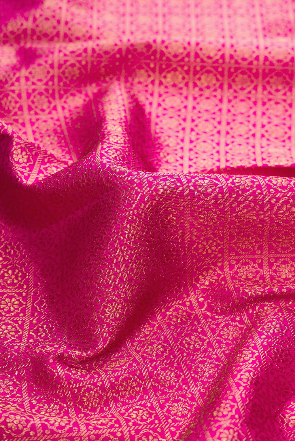 Close up of Dark Pink Dual Tone Kanjivaram Silk Saree with Zari Brocade on the body and Zari Border.  displaying folds