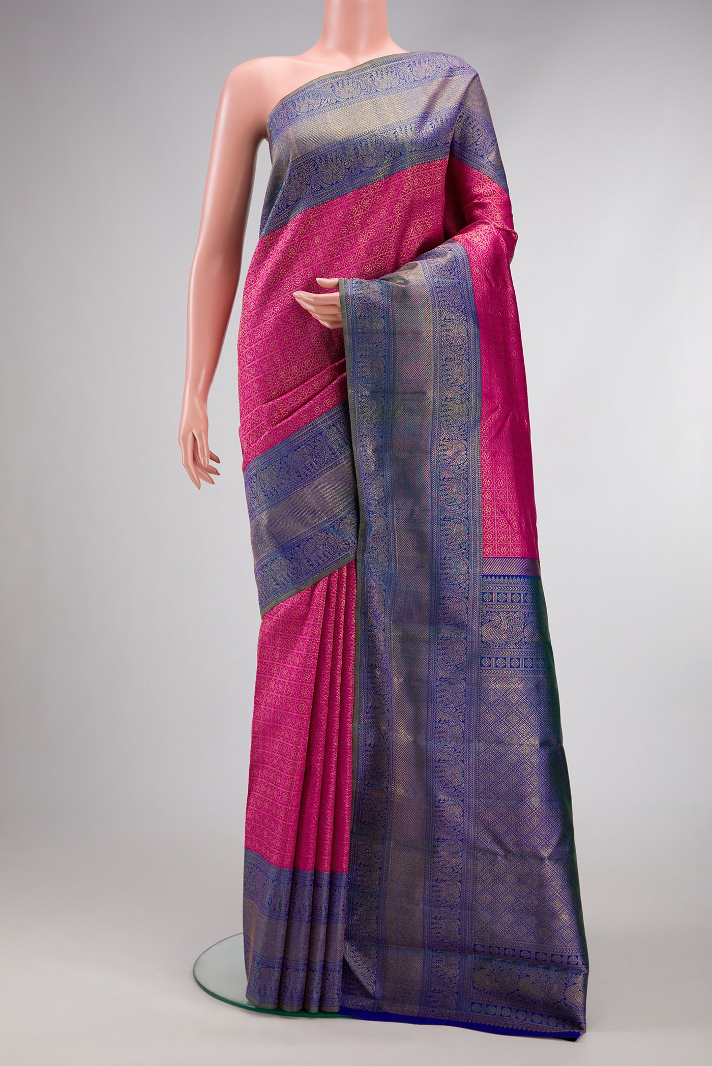 Dark Pink Dual Tone Kanjivaram Silk Saree with Zari Brocade on the body and Zari Border.  displayed on a mannequin