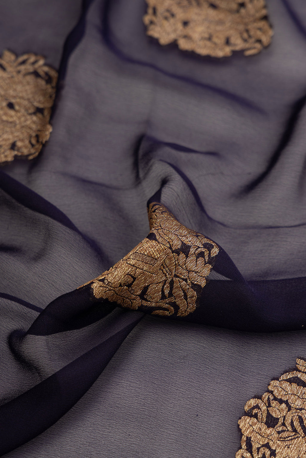 Close up of Navy Blue Dual Tone Mysore Georgette Saree with Zari Butta on the body and Zari Border.  displaying folds