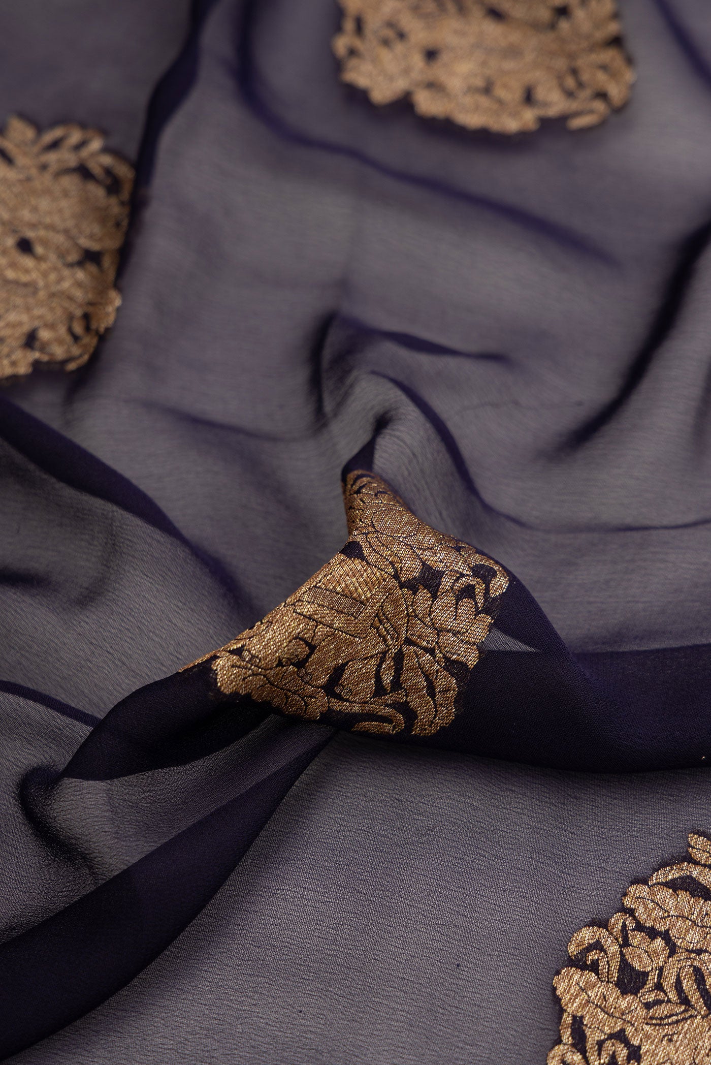 Close up of Navy Blue Dual Tone Mysore Georgette Saree with Zari Butta on the body and Zari Border.  displaying folds