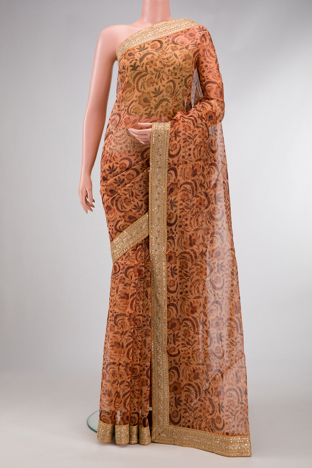 Orange Dual Tone Organza Silk Saree with Printed design on the body and Embroidery Border.  displayed on a mannequin