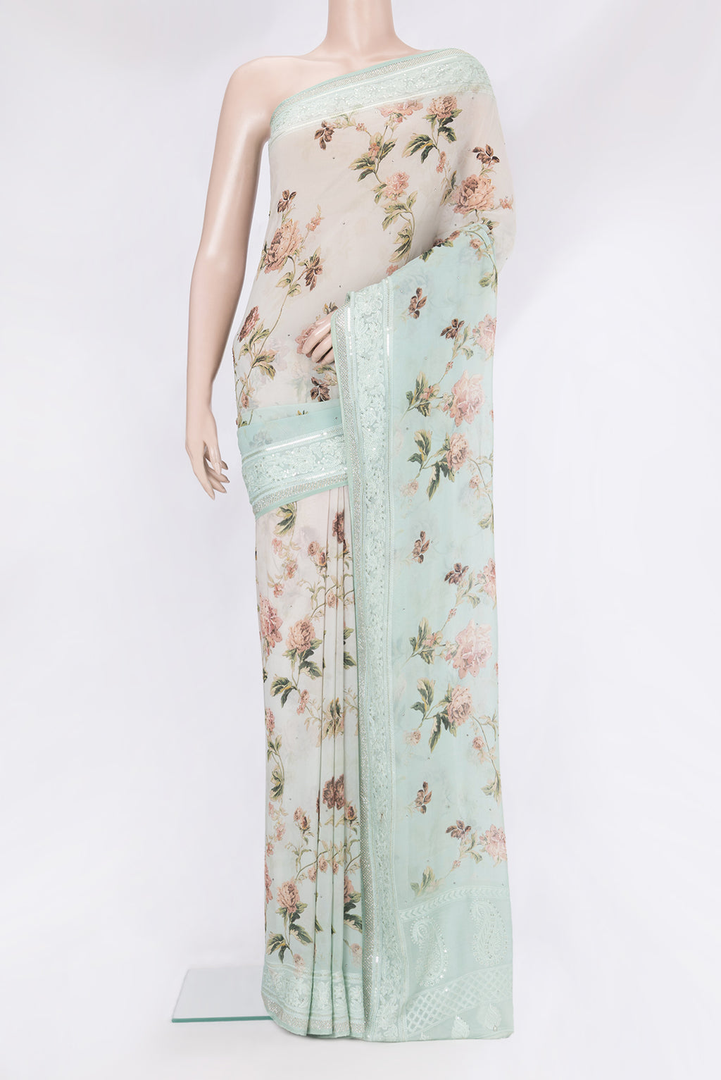 Light Green Georgette Saree with Embroidery on the body and Embroidery Border.  displayed on a mannequin