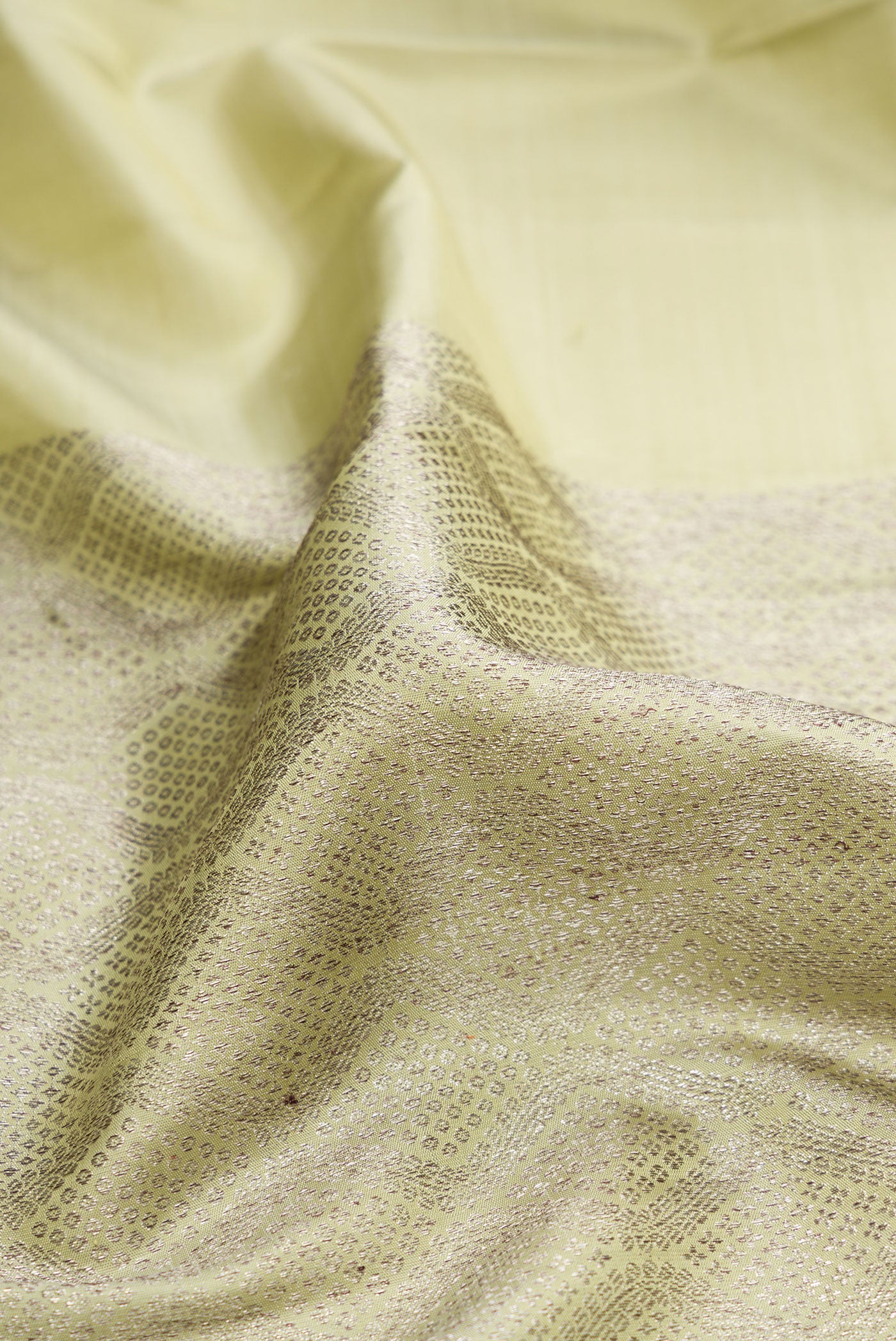 Close up of Pista Green Kanjivaram Silk Saree with Zari Brocade on the body and Without Border.  displaying folds