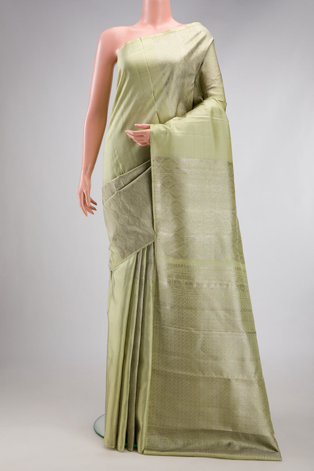 Pista Green Kanjivaram Silk Saree with Zari Brocade on the body and Without Border.  displayed on a mannequin