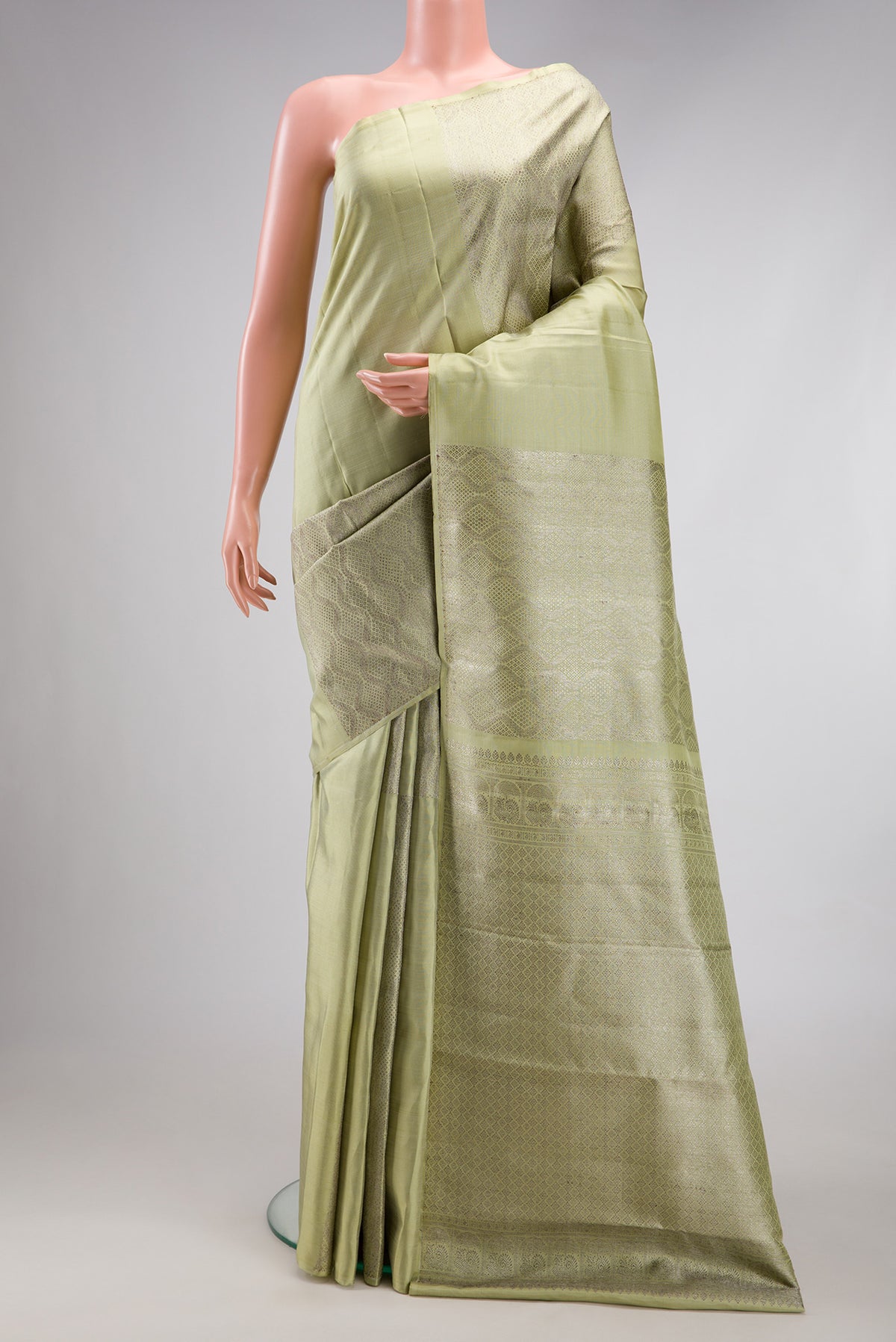 Pista Green Kanjivaram Silk Saree with Zari Brocade on the body and Without Border.  displayed on a mannequin