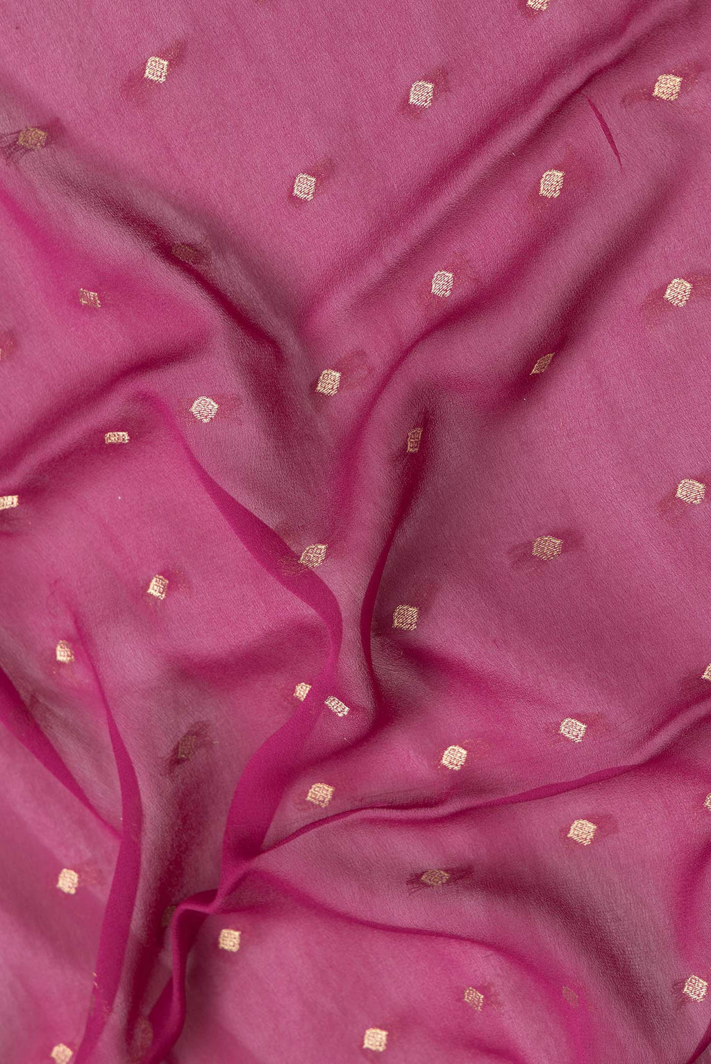 Close up of Magenta Dual Tone Mysore Georgette Saree with Zari Butta on the body and Fancy Border.  displaying folds