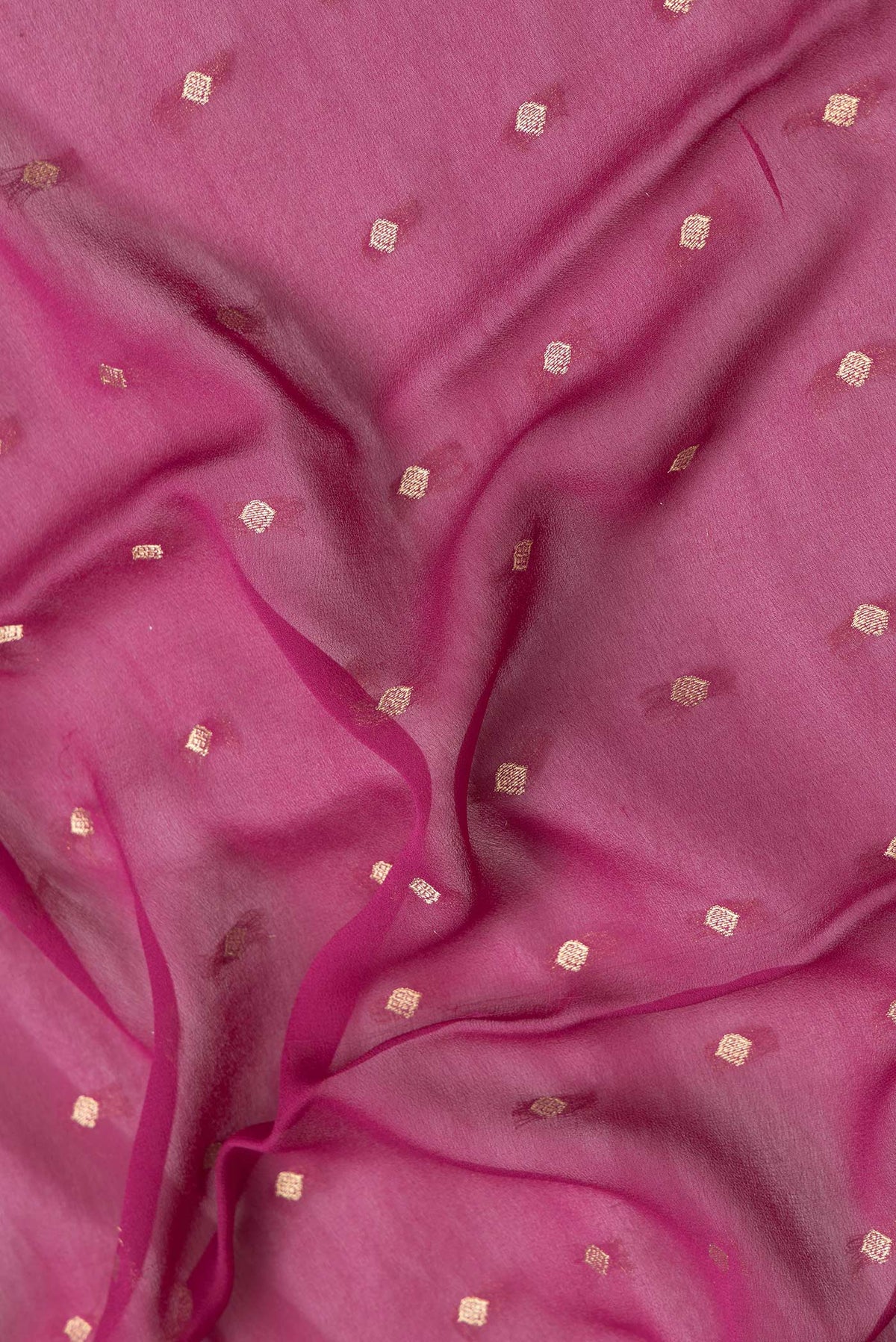 Close up of Magenta Dual Tone Mysore Georgette Saree with Zari Butta on the body and Fancy Border.  displaying folds