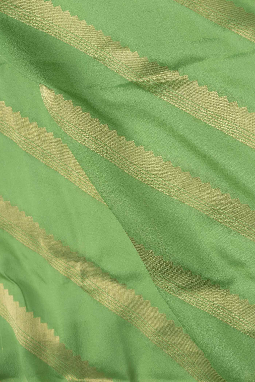 Close up of Green Mysore Crepe Saree with Stripes on the body and Zari Border displaying folds