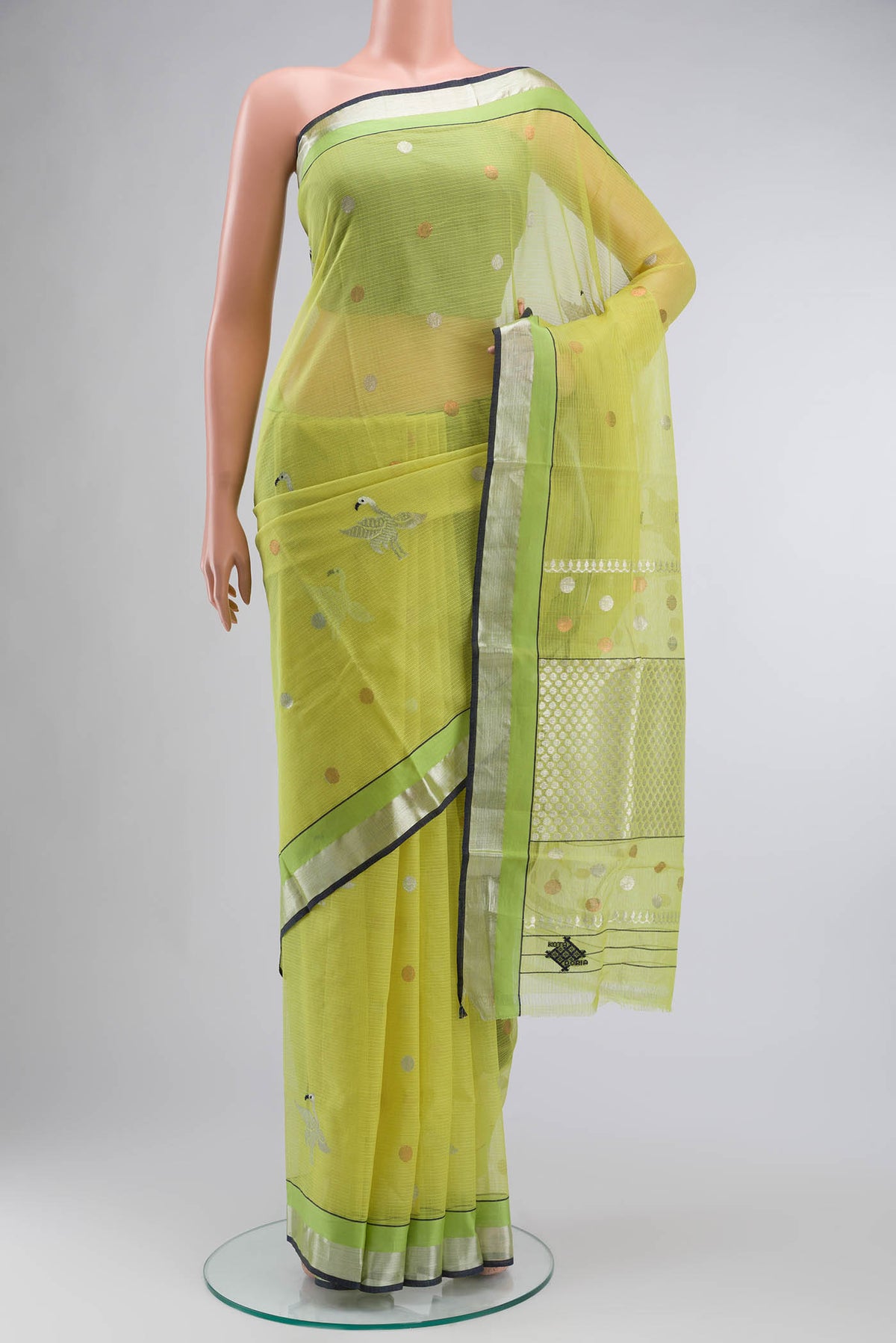 Green Kota Silk Saree with Zari And Thread Butta on the body and Zari Border displayed on a mannequin