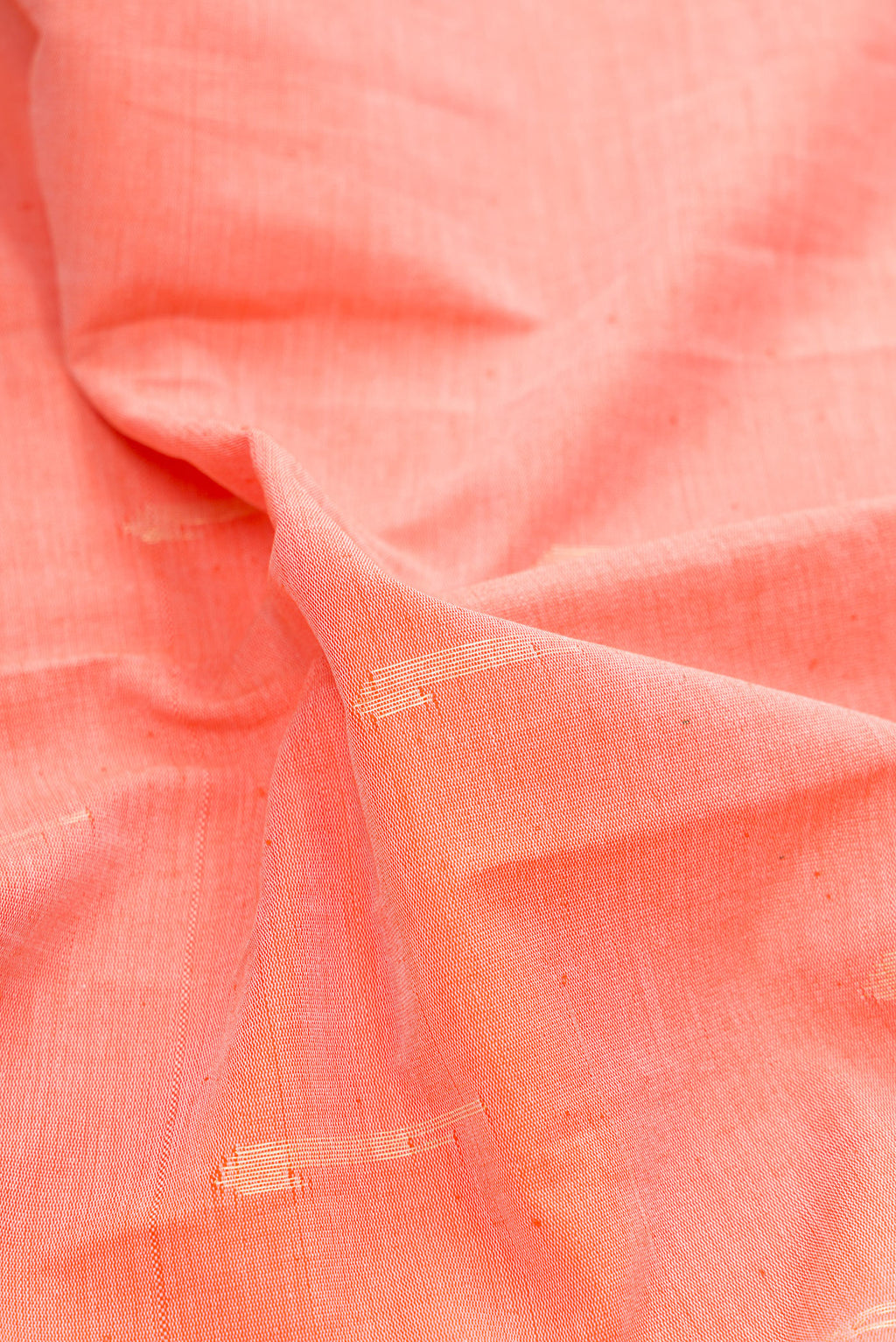 Close up of Peach Paithani Cotton Saree with Zari Butta on the body and Paithani Border.  displaying folds