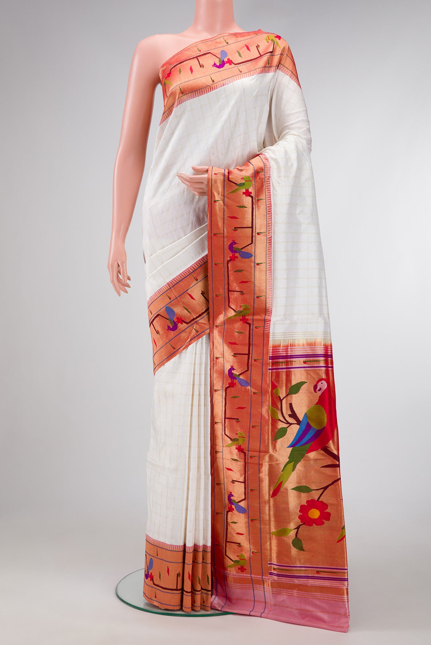 White Dual Tone Paithani Silk Saree with Checked design on the body and Paithani Border.  displayed on a mannequin