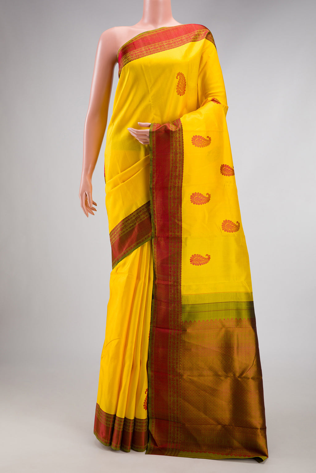 Yellow Kanchipuram Silk Saree with Thread Butta on the body and Thread Border.  displayed on a mannequin