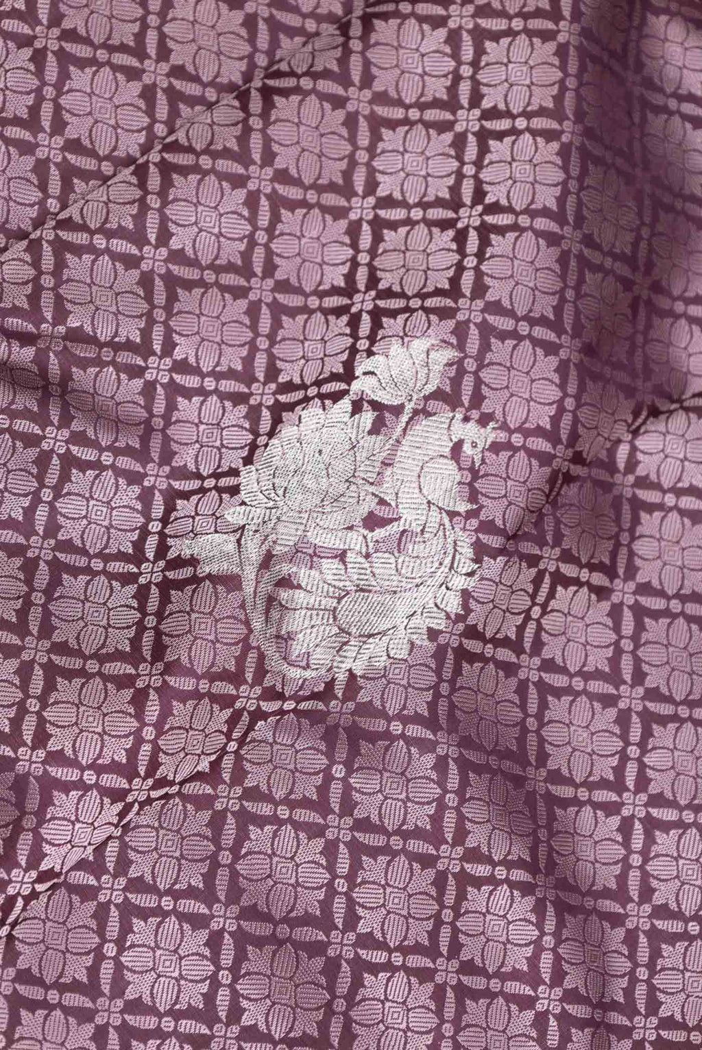 Close up of Burgundy Dual Tone Kanchipuram Silk Saree with Jacquard With Zari Butta on the body and Zari Border displaying folds