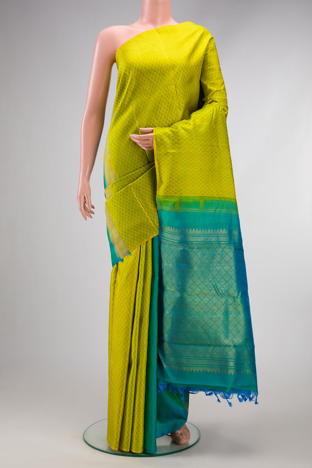Yellow Dual Tone Kanjivaram Silk Saree with Half And Half on the body and Without Border.  displayed on a mannequin