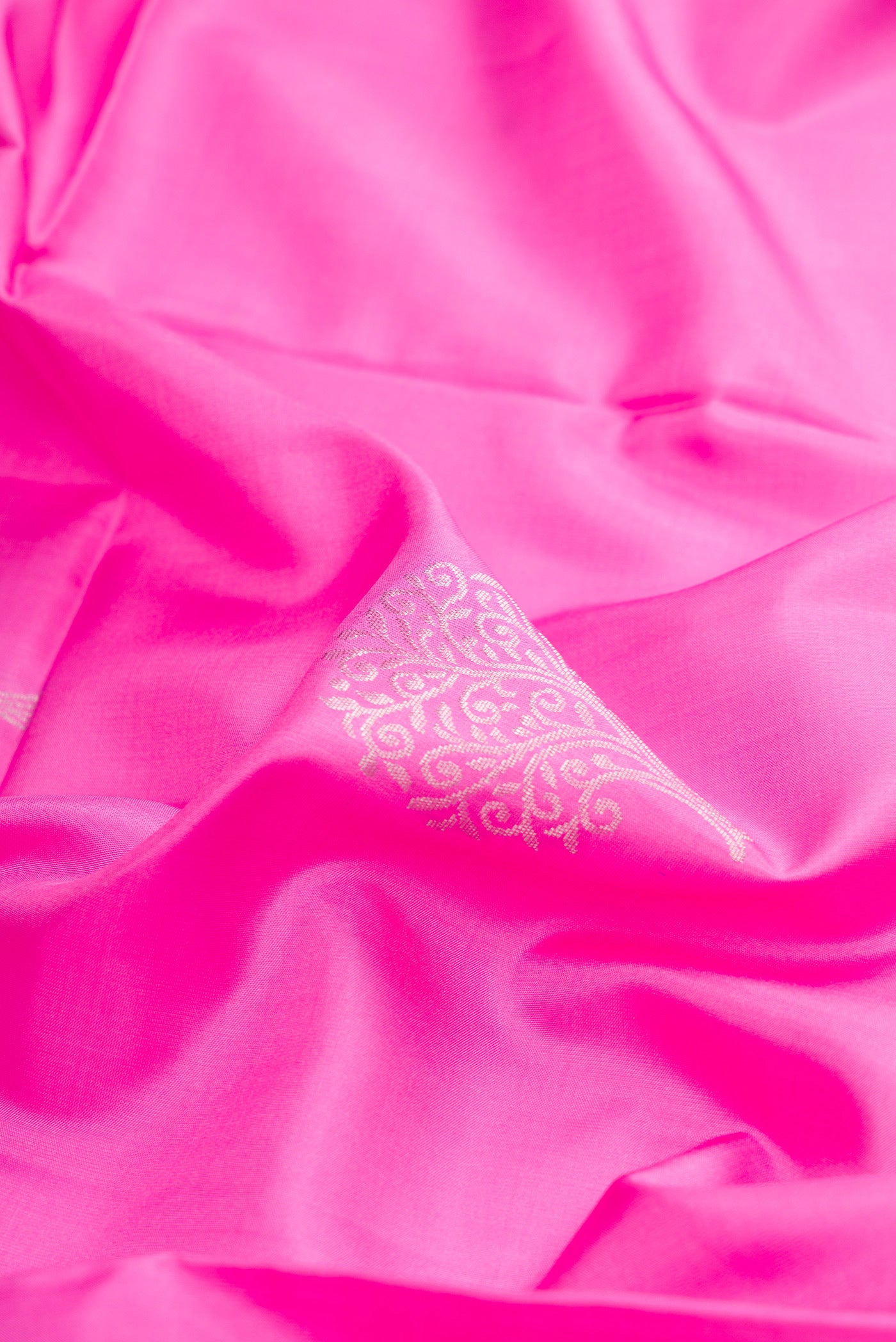 Close up of Pink Soft Silk Saree with Zari Butta on the body and Zari Border.  displaying folds